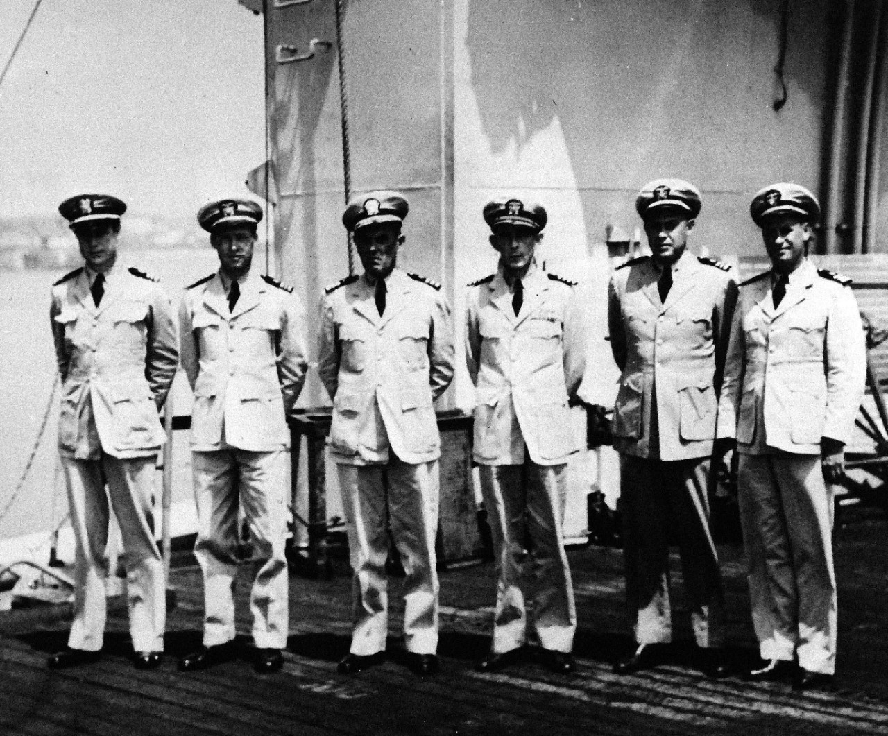 <p>80-G-49185: Capture of German Submarine U-505, June 4, 1944. Commanding Officers of various ships in Task Group that captured U-boat, U-505. Shown on flight deck of USS Guadalcanal (CVE 60). Left to right: Lieutenant Commander Means Johnston Jr., Lieutenant Commander Edwin H. Headland, Commander Frederick S. Hall, Captain Daniel V. Gallery, Commander Dudley S. Knox, and Lieutenant Commander George W. Casselman, May 16, 1945.&nbsp;</p>
