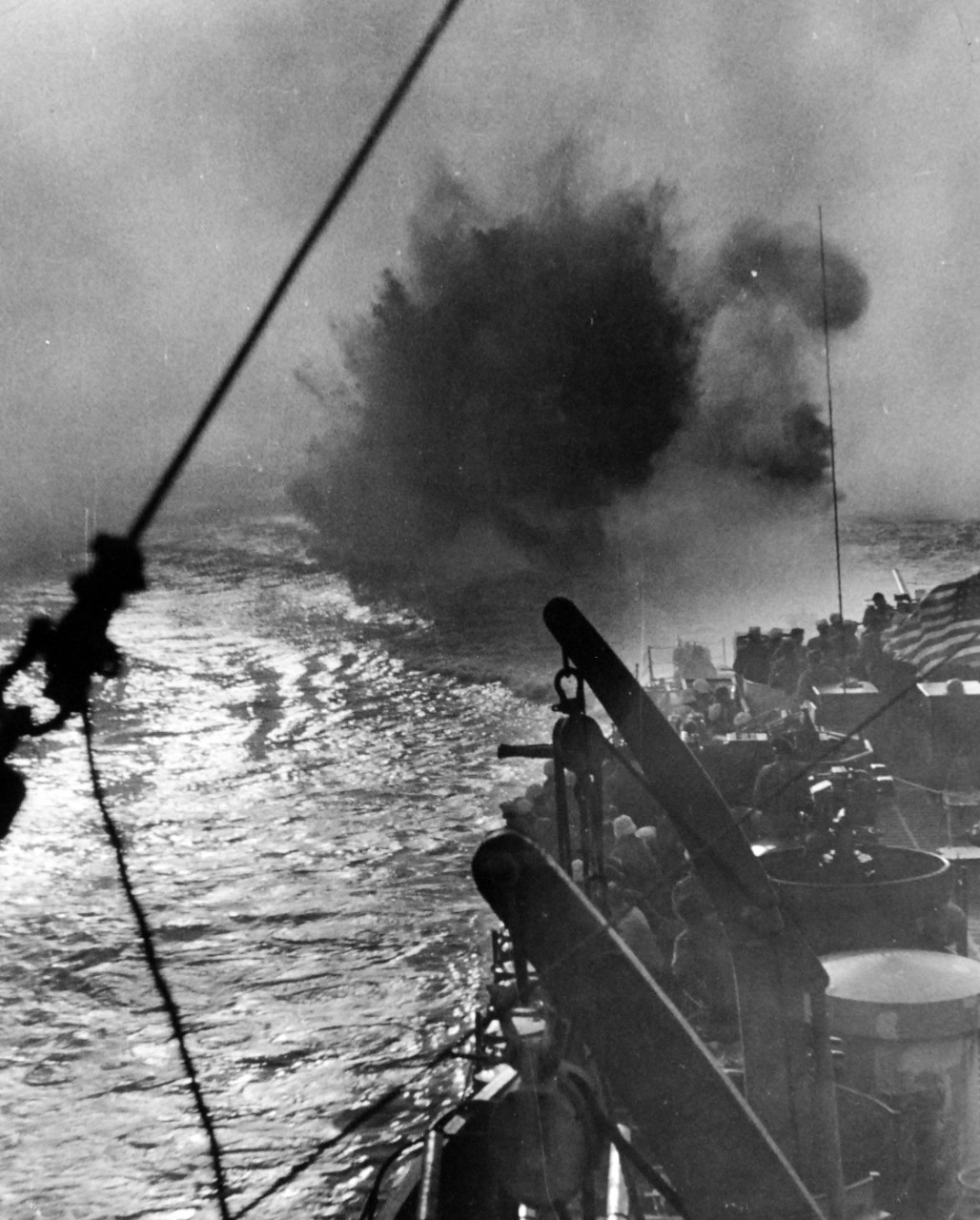 26-G-4555:  Sinking of German U-boat, U-853, May  1945.     A Depth Charge raises a geyser off the stern of a Coast Guard manned frigate off Point Judith, Rhode Island, on May 6, 1945. Teaming with three Navy vessels, the Coast Guard manned USS Moberly (PF-63) attacks U-853, which a few hours earlier had torpedoed an American collier with the loss of four lives.  Sound contact was made with the submarine by USS Atherton (DE-169) and patterns of depth charges were planted by all ships of the group until wreckage of the marauder boiled to the surface.       Official U.S. Coast Guard Photograph, now in the collections of the National Archives.  (2017/09/05). 