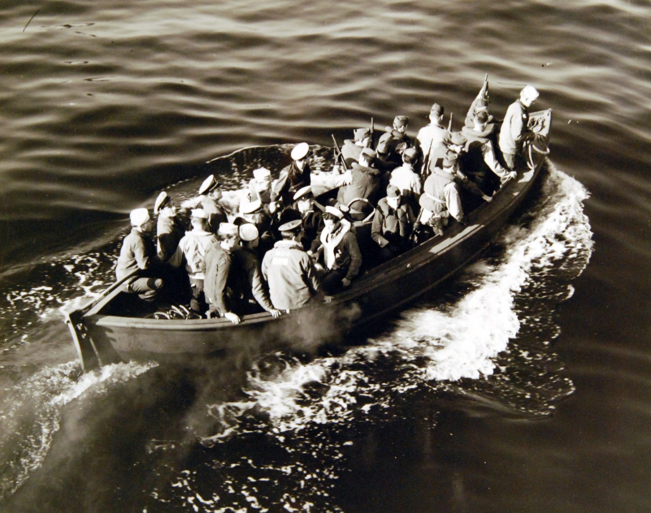 80-G-320307: Surrender of German U-boats, WWII.  Surrender of German U-boat, U-858, 700 miles off the New England Coast to two destroyer escorts, May 10, 1945.  Shown:  A boarding party from USS ATR-57 sets out for U-858.    Official U.S. Navy Photograph, now in the collections of the National Archives.  (2017/07/18).