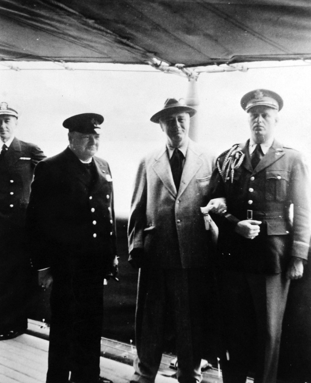 80-G-26853: Atlantic Charter, August 1941.  Prime Minister Winston S. Churchill and party coming onboard USS Augusta (CA-31) during the Atlantic Charter meeting.   Prime Minister Churchill and President Franklin D. Roosevelt are shown after the delivery of the message from His Majesty King George VI.    Photograph released August 10, 1941.   Official U.S. Navy Photograph, now in the collections of the National Archives.  (2016/03/22).