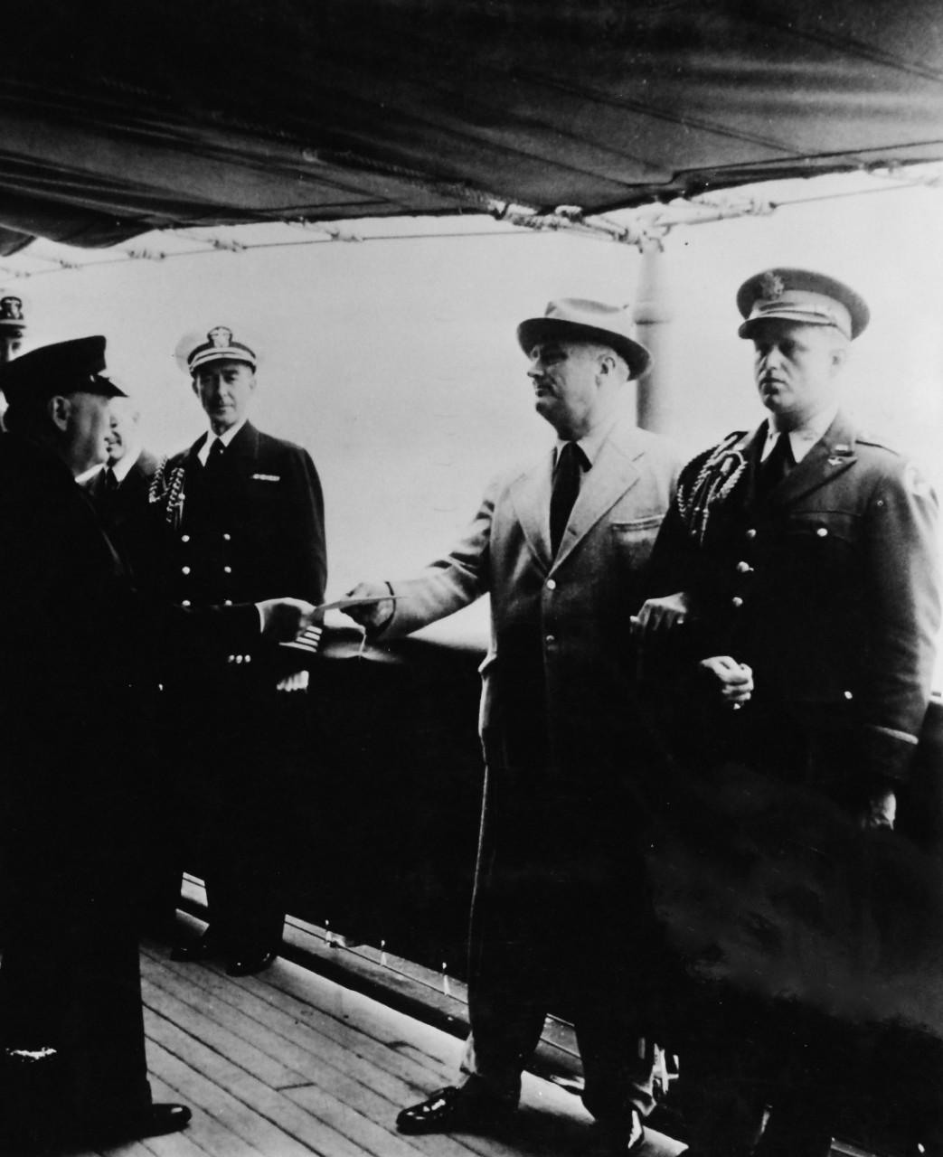 80-G-26855: Atlantic Charter, August 1941.  Prime Minister Winston S. Churchill and party coming onboard USS Augusta (CA-31) during the Atlantic Charter meeting. Being greeted by President Franklin D. Roosevelt.   Photograph released August 1941.   Official U.S. Navy Photograph, now in the collections of the National Archives.  (2016/03/22).