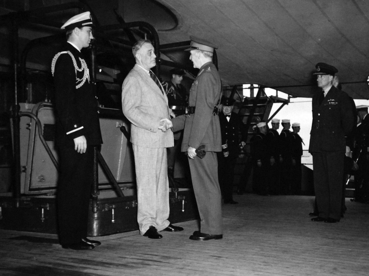 80-G-26868: Atlantic Charter, August 1941.  Informal group photograph on deck of HMS Prince of Wales following church services during the Atlantic Charter.  Left to right:  Ensign Franklin D. Roosevelt; President Roosevelt; Sir John Dill and Marshall Wilfred Freeman.  Photograph released August 1941.   Official U.S. Navy Photograph, now in the collections of the National Archives.  (2016/03/22).