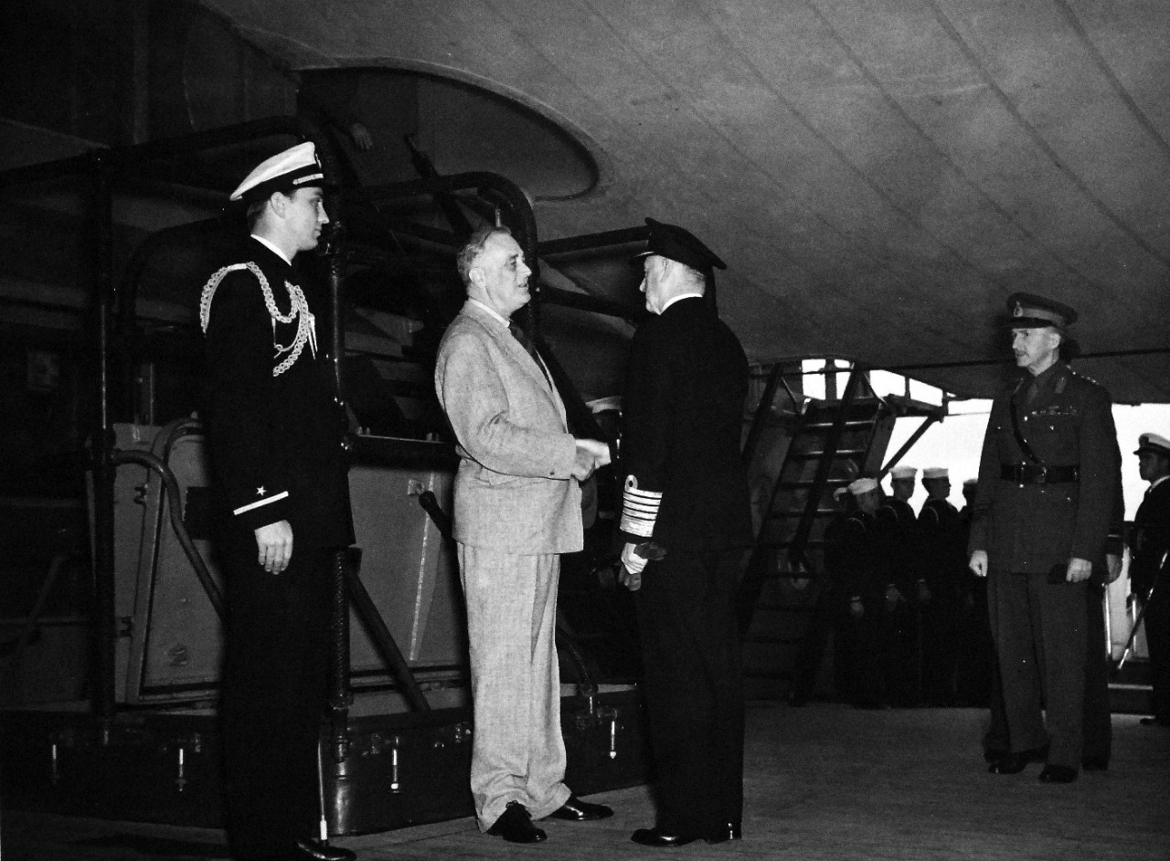 80-G-26880: Atlantic Charter, August 1941.  President Franklin D. Roosevelt bids farewell to Sir Dudley Pound on board USS Augusta (CA-31).  General Sir John Dill is in the background.  Next to the President is his son Ensign Roosevelt.   Photograph released August 1941.   Official U.S. Navy Photograph, now in the collections of the National Archives.  (2016/03/22).