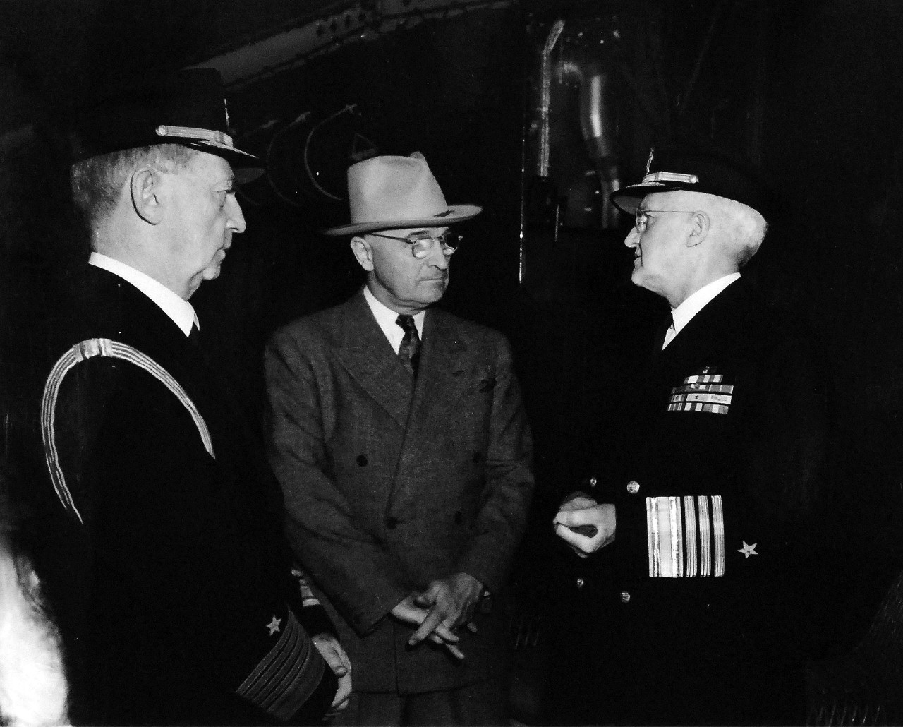 80-G-49970:  Potsdam Conference, 17 July – 2 August 1945.   Shown:  Fleet Admiral William D. Leahy, President Harry S. Truman and Admiral Harold R. Stark conferring before the President left the ship at Antwerp, Belgium.  Photographed by CPhoM Wm. Belknap, received July 15, 1945. U.S. Navy Photograph, now in the collections of the National Archives.  (2016/02/23).