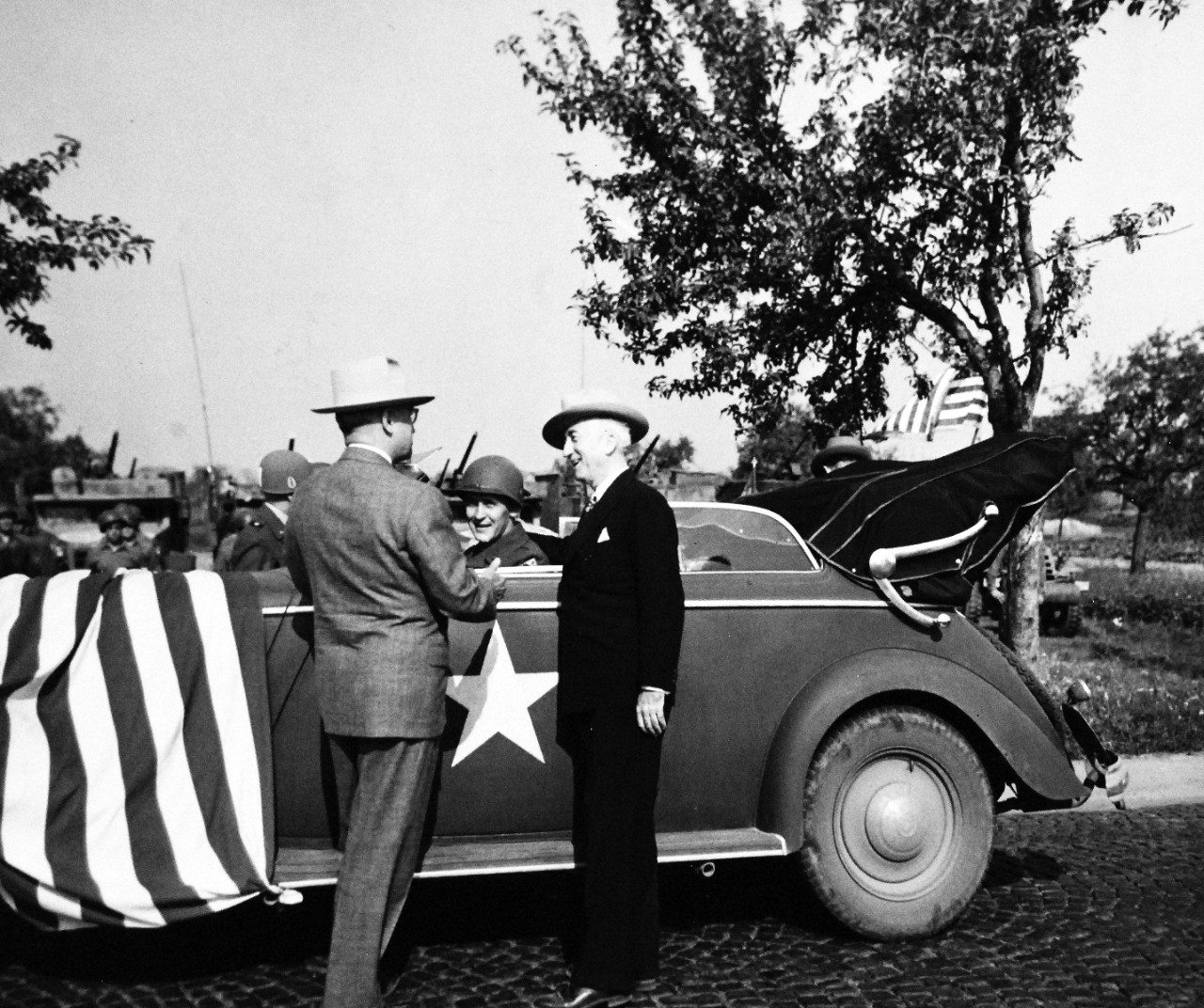 80-G-700166: Potsdam Conference, July-August 1945.  President Harry S. Truman introducing his driver, Private First Class Warren E. Baker to Secretary of State James F. Byrnes, both from the same home town.  President Truman had been inspecting the 3Rd Armored Division near Frankfurt, Germany.  Photographed by CPhoM William Belknap Jr., released July 26, 1945.   Official U.S. Navy Photograph, now in the collections of the National Archives.  (2016/02/23).