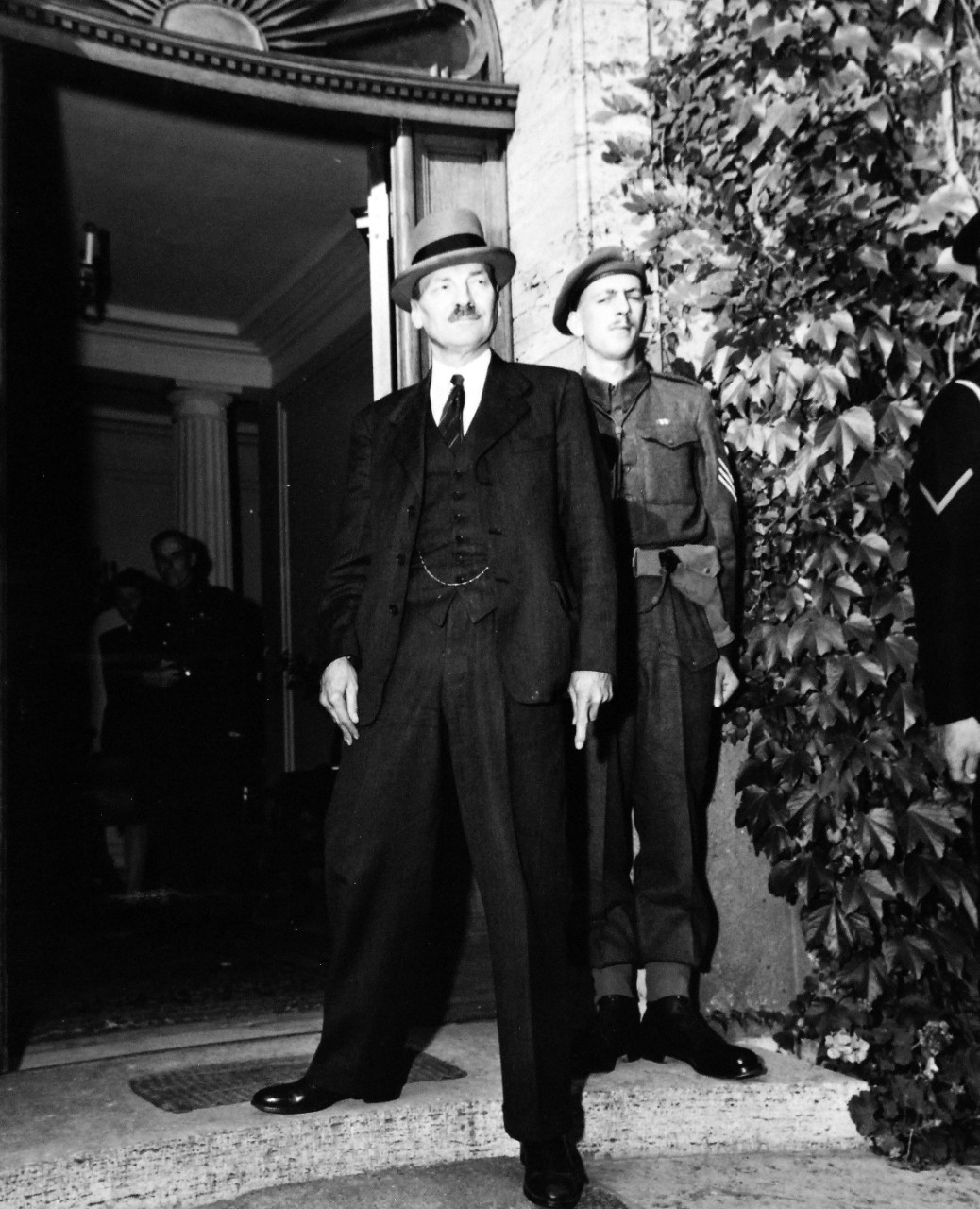 80-G-700187: Potsdam Conference, July-August 1945. Clement Atlee, new Prime Minister of Great Britain, returns to Potsdam, Germany, for further “Big Three” conferences.   He is about to enter house formerly occupied by Winston Churchill.  Photographed by CPhoM William Belknap Jr., released July 28, 1945.   Official U.S. Navy Photograph, now in the collections of the National Archives.  (2016/02/23).