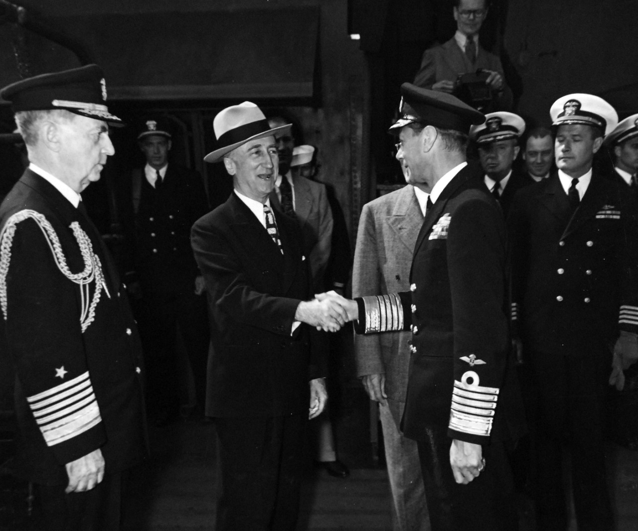 80-G-700231:  Potsdam Conference, July-August 1945. King George VI aboard USS Augusta (CA 31) for a return visit to President Harry S. Truman while the ship is in Plymouth Harbor, England.  Shown: Fleet Admiral William D. Leahy, Secretary of State James F. Byrnes, King George, and Captain James Foskett.  Official Photograph released August 1945.  U.S. Navy Photograph, now in the collections of the National Archives.  (2016/02/23).