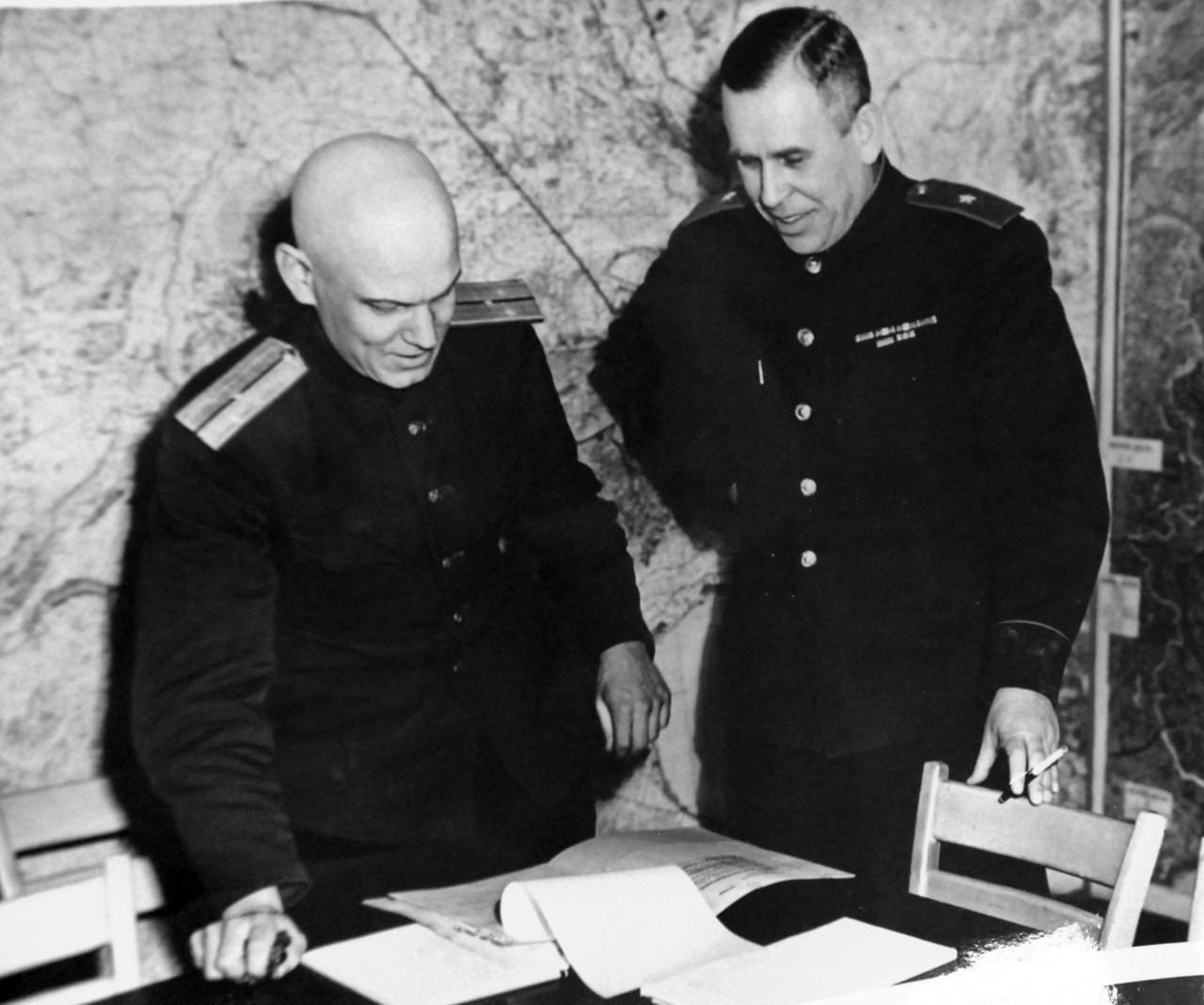 111-SC-27250:  Surrender of Germany, 7 May 1945. At SHAEF Forward Headquarters in Reims, France, Russian military representatives look over the Unconditional Surrender terms given to all German fighting forces.  Shown, left to right:  Lieutenant Ivan Cherniaeff, Aide and Interpreter, and Major General of Artillery Ivan Alexeyevich Susloparov.  This photograph is dated May 5, 1945.   U.S. Army Photograph.  This print was fading.  Courtesy of the Library of Congress Collection, Lot-8988. (2015/10/16).