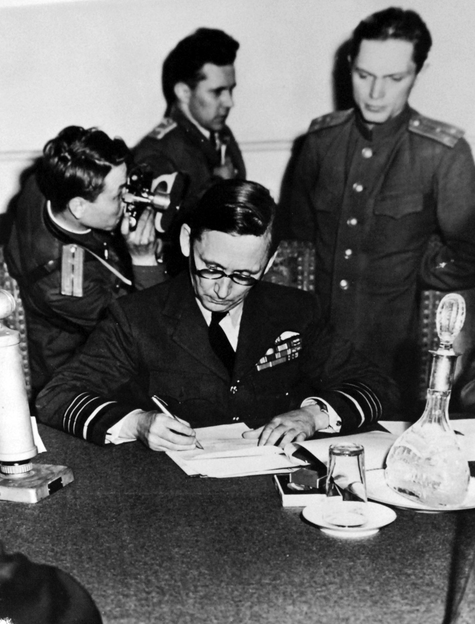 111-SC-27434: Surrender of Germany, 7 May 1945.  Air Chief Marshall Sir Arthur Tedder, Deputy Supreme Commander, signs the ratified “Unconditional Surrender” terms at Russin Headquarters in Berlin, Germany.  These terms were agreed to at Riems, France.  U.S. Army Photograph.  Courtesy of the Library of Congress Collection, Lot-8988. (2015/10/16).