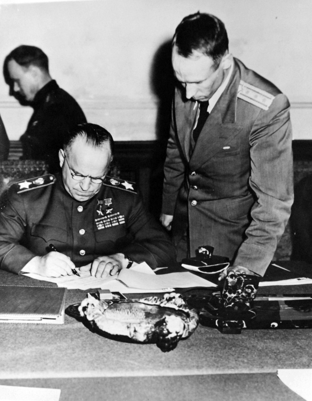 111-SC-27435: Surrender of Germany, 7 May 1945. Field Marshall George K. Zhukov, Deputy Commander in Chief of all Soviet Forces signs the ratified Unconditional Surrender terms as agreed upon at Reims for the Russian Army.  U.S. Army Photograph. Courtesy of the Library of Congress Collection, Lot-8988. (2015/10/16).