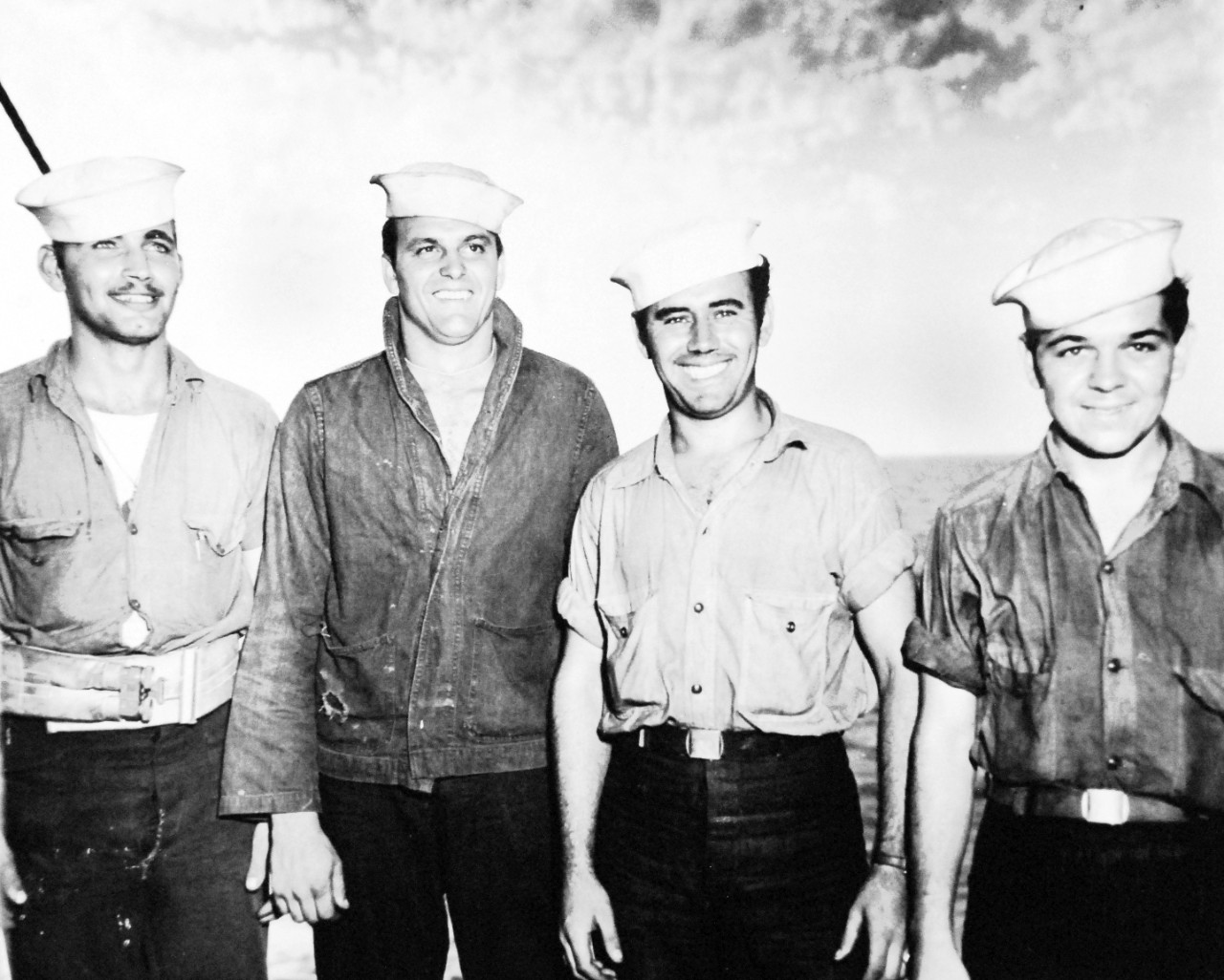 26-G-2047:  Operation Avalanche,  September 1943.  They Helped Push the Nazis Back.  These four crew members of a tank lighter attached to a U.S. Coast Guard manned transport helped push the Germans back from the beaches at Paestum, near Salerno.  Manning a 50 caliber machine gun, Coast Guardsman Richard Cook, second from left, during the lighter’s first trip to the beach successfully broke up a Nazi machine gun nest.  From left to right:  Coast  Guardsman Leonard Ruehle; Coast Guardsman Cook; US Navy sailor A.E. Lessard; and US Navy sailor Harry W. Lesson.    Official U.S. Coast Guard Photograph, now in the collections of the National Archives.   (2015/5/19). 