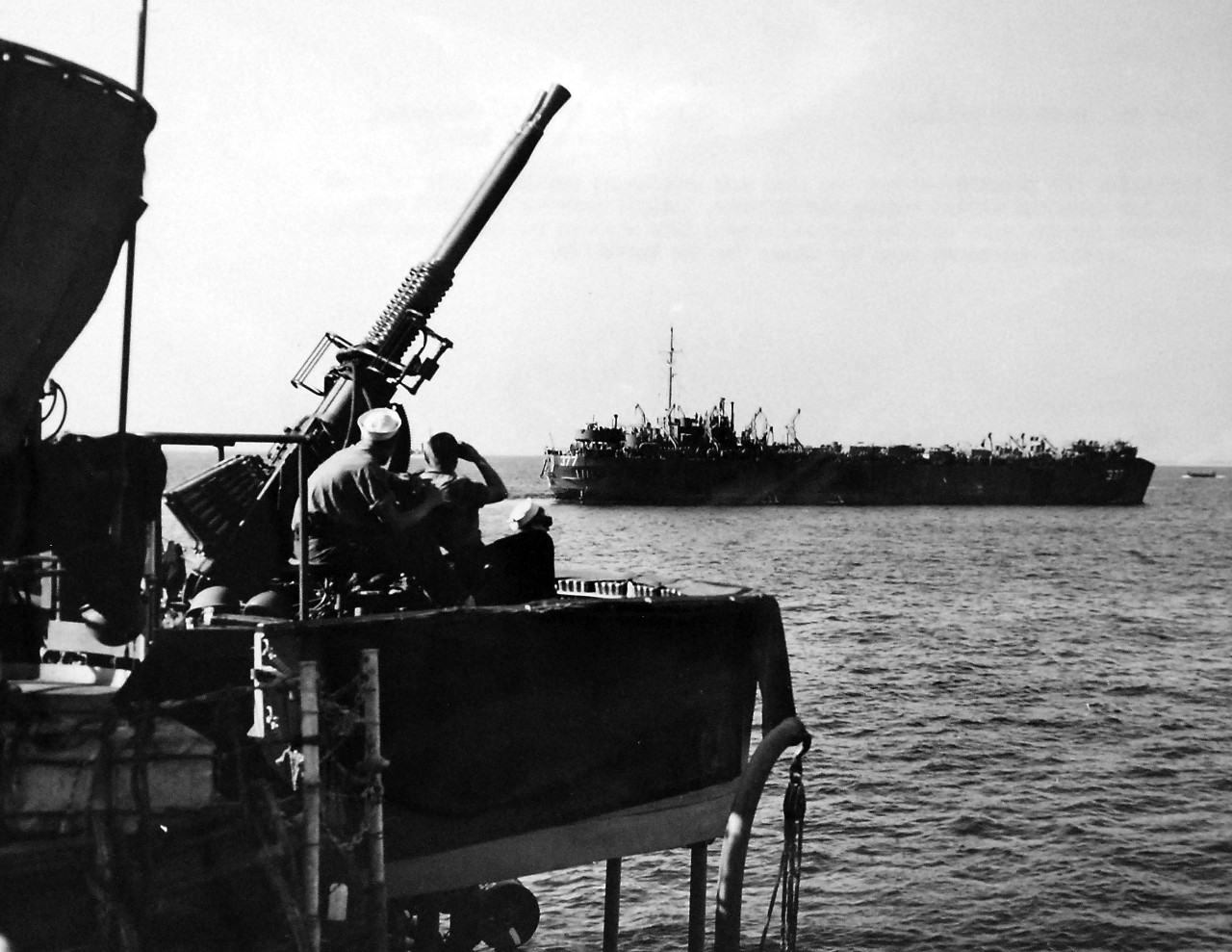 LC-Lot-916-1:   Operation Avalanche, September 1943.  Interlude off Salerno.  After the rear and tension of battle, a calm interval settles upon the Allied convoy off Salerno, Italy.  Guns and men cool off, prepare for the next call to action.   Giant LSTs (shown LST-377) ride on the quiet sea, while anti-aircraft gun crews scan the skies for the Luftwaffe.   Official Navy Photograph. Photographed through Mylar sleeve.   Courtesy of the Library of Congress.  (2016/05/19). 