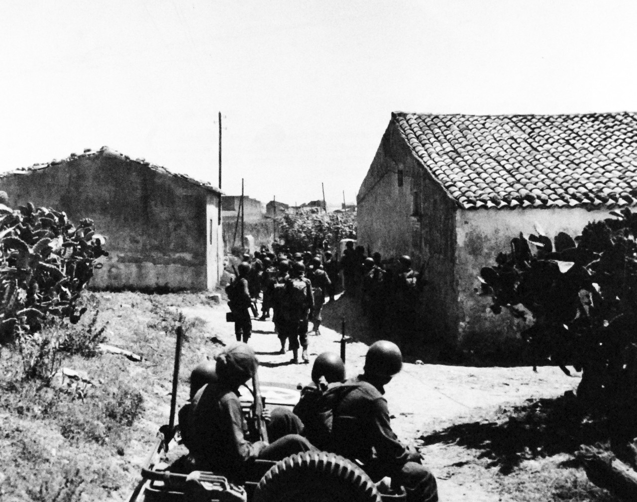 80-G-42502:    Operation Husky, July-August 1943.    Scoglitti, Sicily, after successful landing operations in the invasion of Sicily.  American troops start their drive across the western and northern sectors, some by foot and some by jeep, 17 July 1943.  Official U.S. Navy photograph, now in the collections of the National Archives.    (2014/8/13). 