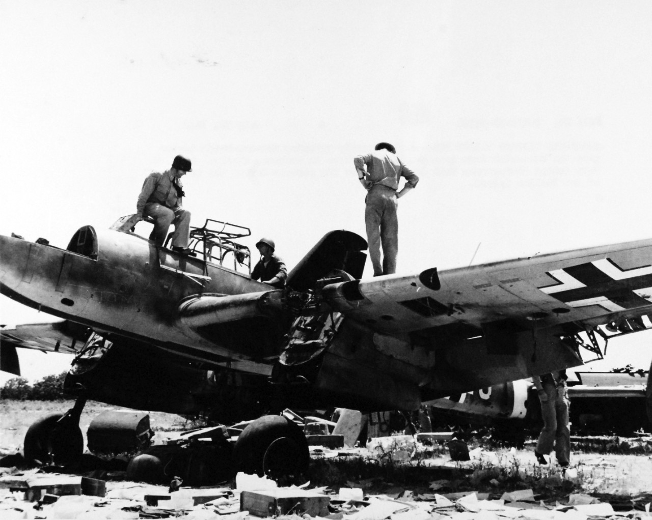 80-G-54546:  Operation Husky, July-August 1943.   Americans look over a permanently grounded Messerschmidt after the invasion of Sicily on July 10th.    Photograph, July 1943.   Official U.S. Navy photograph, now in the collections of the National Archives.   (2016/07/19).