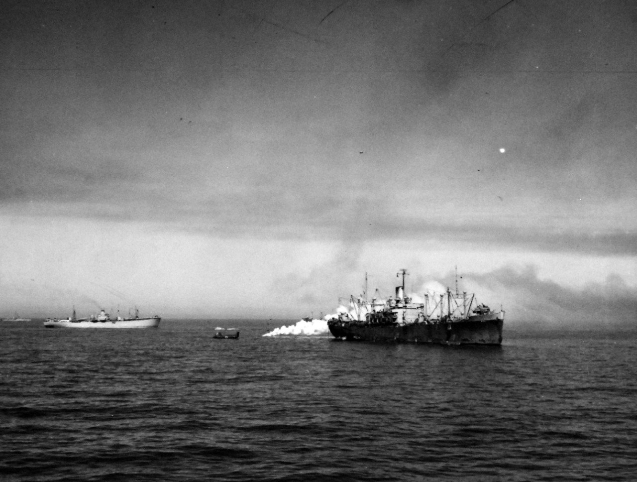 80-G-74831:   Operation Husky, July-August 1943.   Beginning of smoke screens to cover ships before an air attack off shore at Gela, Sicily.   Photographed by USS Boise (CL-47), July 10 1943.    Official U.S. Navy Photograph, now in the collections of the National Archives.  (2018/02/14).    