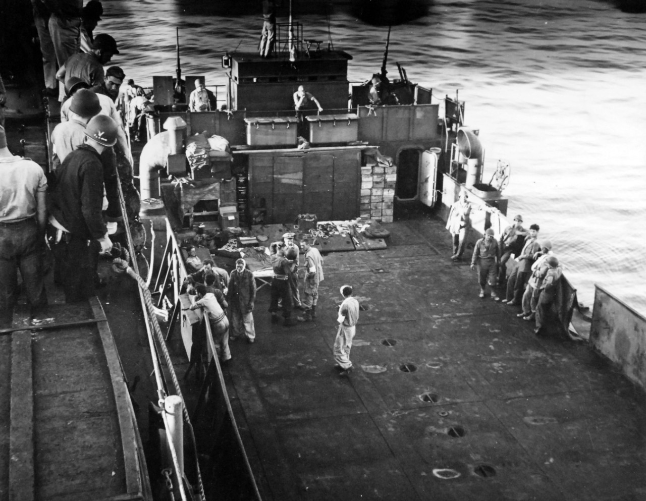 80-G-74837:   Operation Husky, July-August 1943  Bringing U.S. wounded and German prisoners aboard USS Boise (CL-47) for treatment off shore Gela, Sicily.  Photographed by USS Boise (CL-47), July 13 1943.    Official U.S. Navy Photograph, now in the collections of the National Archives.  (2018/02/14).    