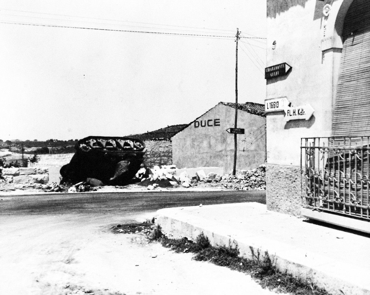 80-G-86219:  Operation Husky, July-August 1943.  Battle damage shown after successful landing operations by the Allies in the invasion of Sicily.  Note: Italian light tank destroyed by 105 M.M. gun at Comiso.     Photograph received July 14, 1943.      U.S. Navy Photograph, now in the collections of the National Archives.  (2017/01/17).
