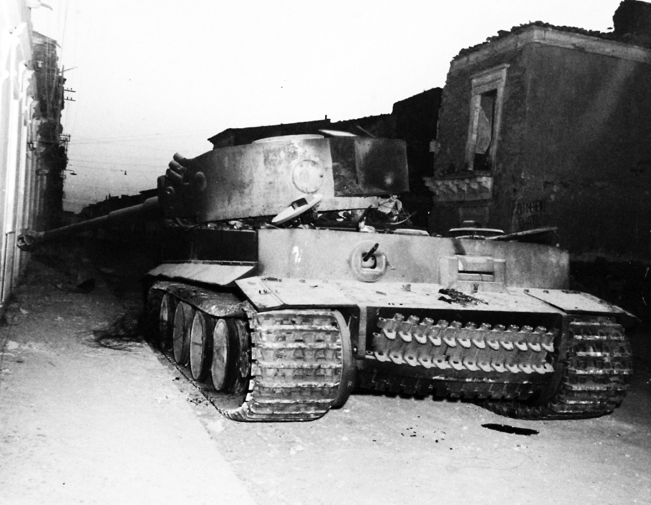 80-G-86222:  Operation Husky, July-August 1943.  Battle damage shown after successful landing operations by the Allies in the invasion of Sicily.  Note: Wreckage of German Mark VI tank at Biscari.     Photograph received July 14, 1943.      U.S. Navy Photograph, now in the collections of the National Archives.  (2017/01/17).