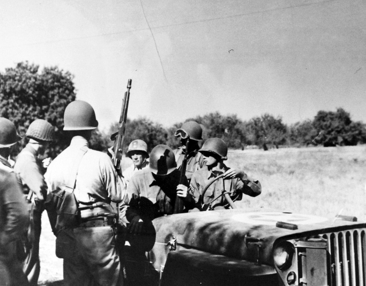 LC-Lot-805-38: Operation Husky, July-August 1943. Navy Comes Ashore.  His and of the landing operations of Sicily successfully begun, Rear Admiral Alan G. Kirk, USN, (rear), goes ashore to watch Major General Troy H. Middleton, (second right), direct ground tactics near Scoglitti.   Photograph released August 3, 1943.  Photographed through Mylar sleeve. U.S. Navy Photograph.  Courtesy of the Library of Congress.  (2015/10/30).
