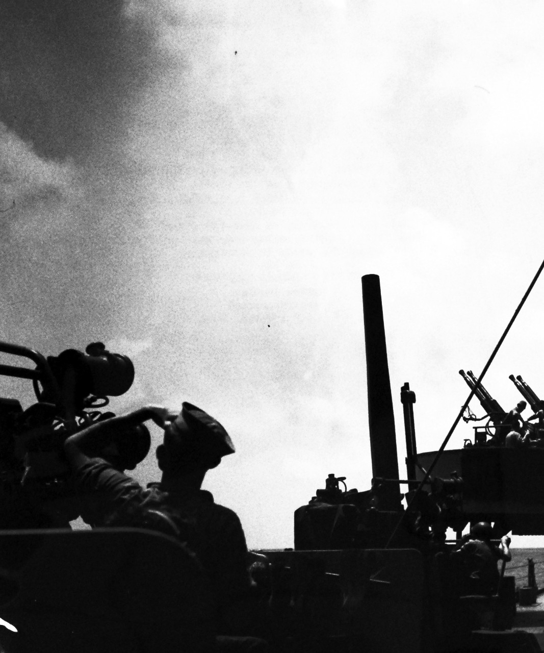 LC-Lot-805-5: Operation Husky - Invasion of Sicily, 9 July – August 17, 1943. Air vs. Sea.  Hurling their deadly answers to the challenge of the Luftwaffe, members of the gun crews onboard a U.S. warship off Sicily eye the skies during the brief intermissions between actions in an air raid.  Note, the anti-aircraft guns to the right.  Photograph released August 17, 1943.  Photographed through Mylar sleeve. U.S. Navy Photograph.  Courtesy of the Library of Congress.  (2015/10/30).