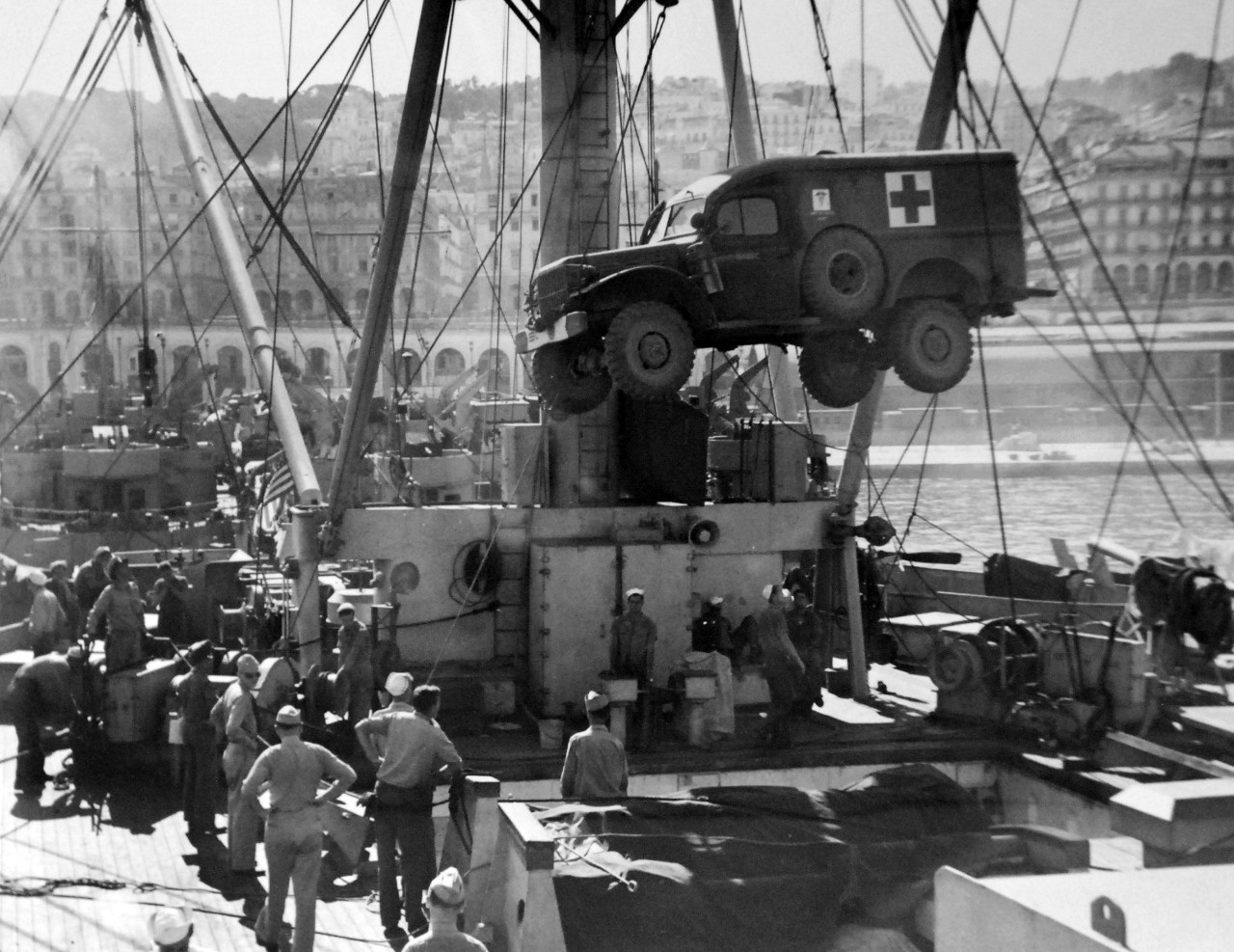 LC-USZ62-97661: Operation Husky, July-August 1943.  Mercy Trucks Accompany Invaders.  U.S. Coast Guardsmen load an ambulance aboard their transport at a North African port as they prepare to sail for Sicily.  U.S. Coast Guard Photograph.  Photographed through Mylar sleeve.  Courtesy of the Library of Congress:  Lot-805.  (2015/10/30).