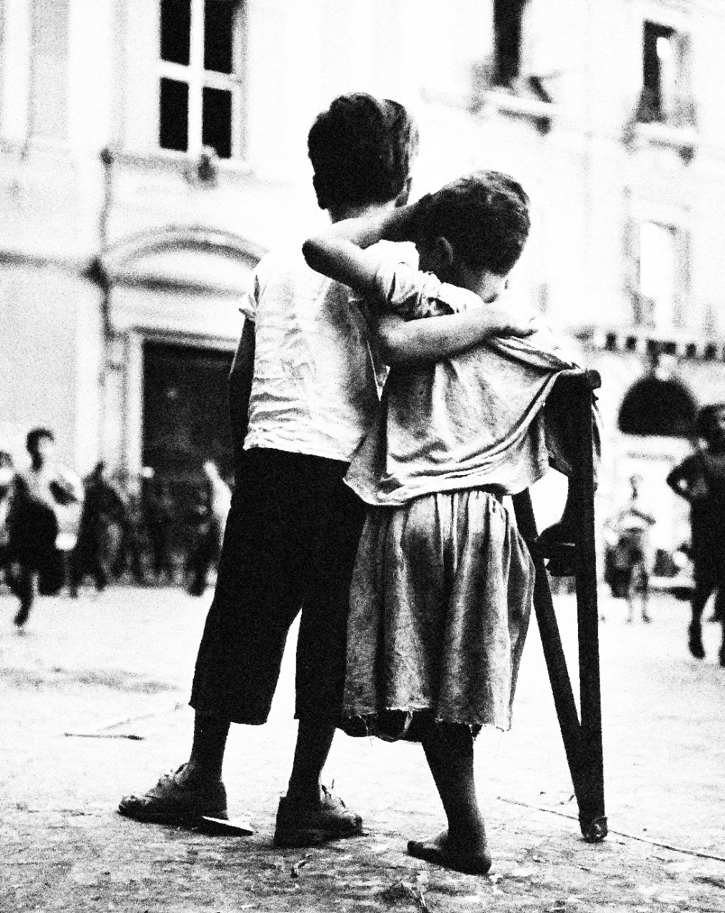 80-G-474128:   Naples, Italy, August 1944.    Children in Naples.  Little boy helps one-legged companion across the street.   Steichen Photography Unit:  Photographed by  Lieutenant Wayne Miller, August 1944.    TR-11306.   Official U.S. Navy Photograph, now in the collections of the National Archives. (2015/12/08).