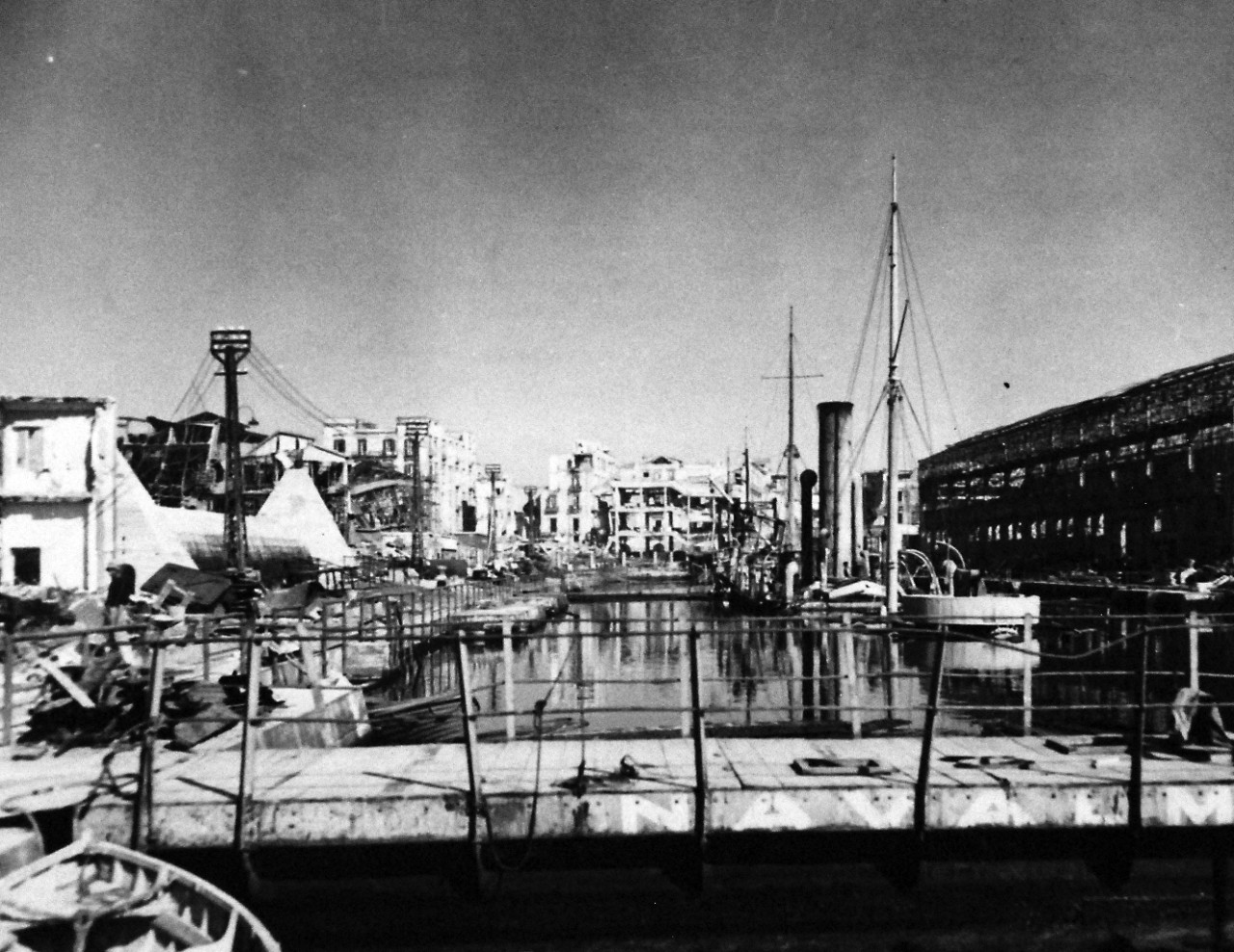 80-G-54361:   Naples, Italy, September 1943.   Damage to the city during that month’s military action.  Shown:  Ships that were in drydock blasted almost beyond repair.   Photograph released November 4, 1943.  Official U.S. Navy photograph, now in the collections of the National Archives.  (2016/06/28).