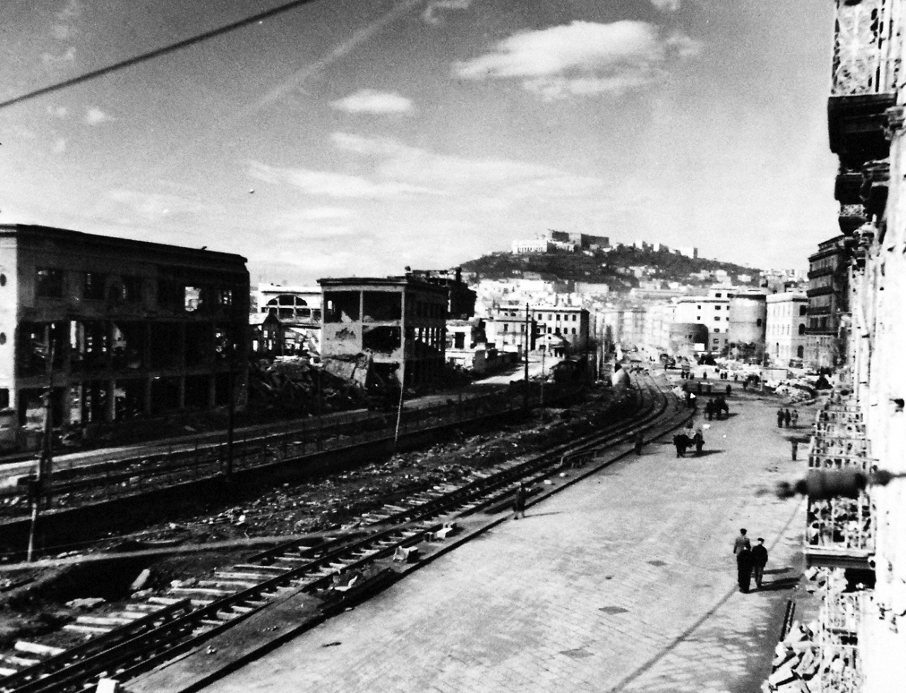 80-G-54364:  Naples, Italy, September 1943.   Damage to the city during that month’s military action.    Shown:  Wrecked buildings line the railroad tracks near the waterfront.  Photograph released November 4, 1943.  Official U.S. Navy photograph, now in the collections of the National Archives.  (2016/06/28).