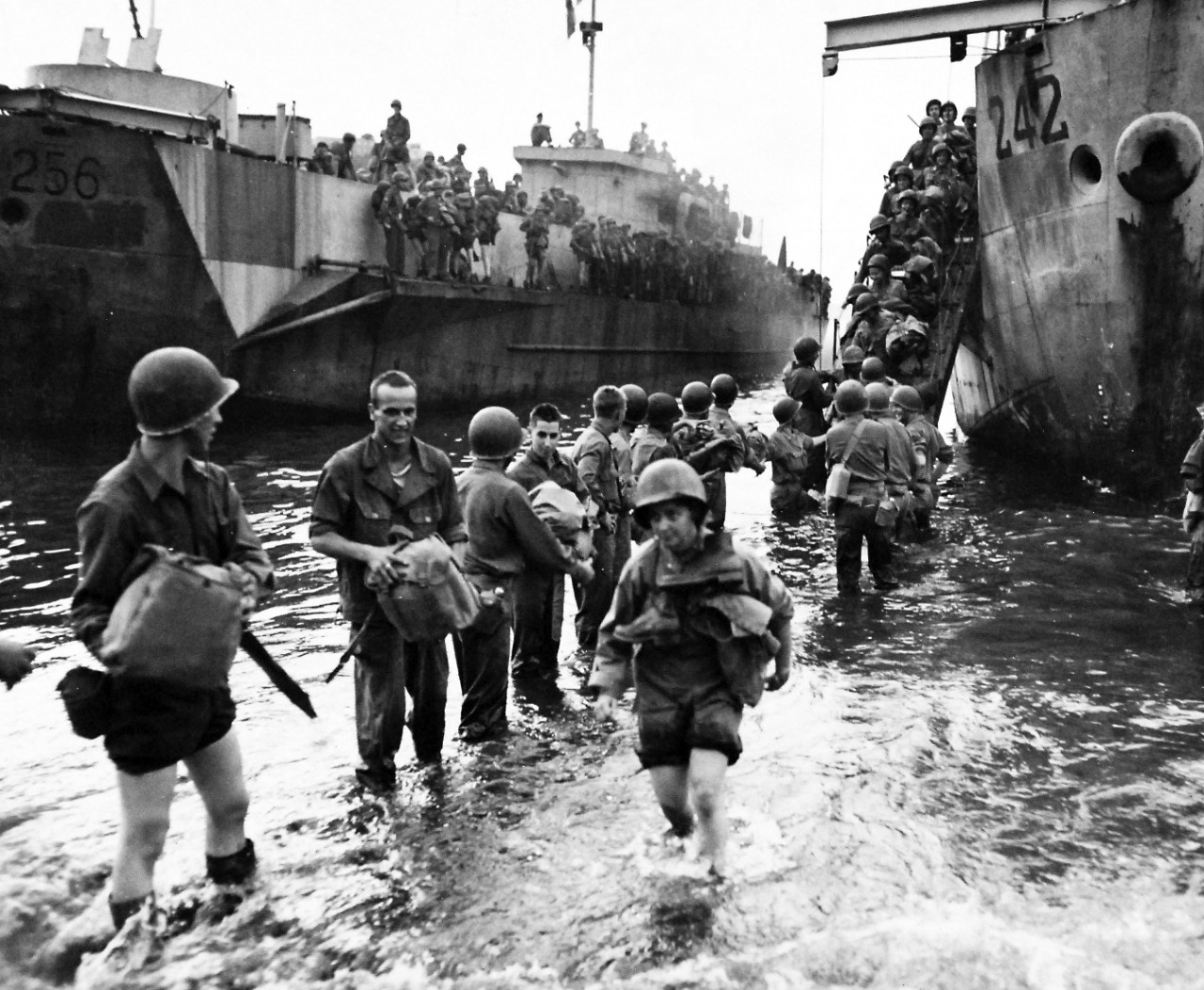 80-G-54371:   Naples, Italy, November 1943.   U.S. Army nurses and soldiers at Naples, Italy, wading ashore from LCI-242.   The nurse in the foreground carries her boots around her neck for safekeeping.   Photograph released November 4, 1943.  U.S. Navy photograph, now in the collections of the National Archives.  (2016/06/28).