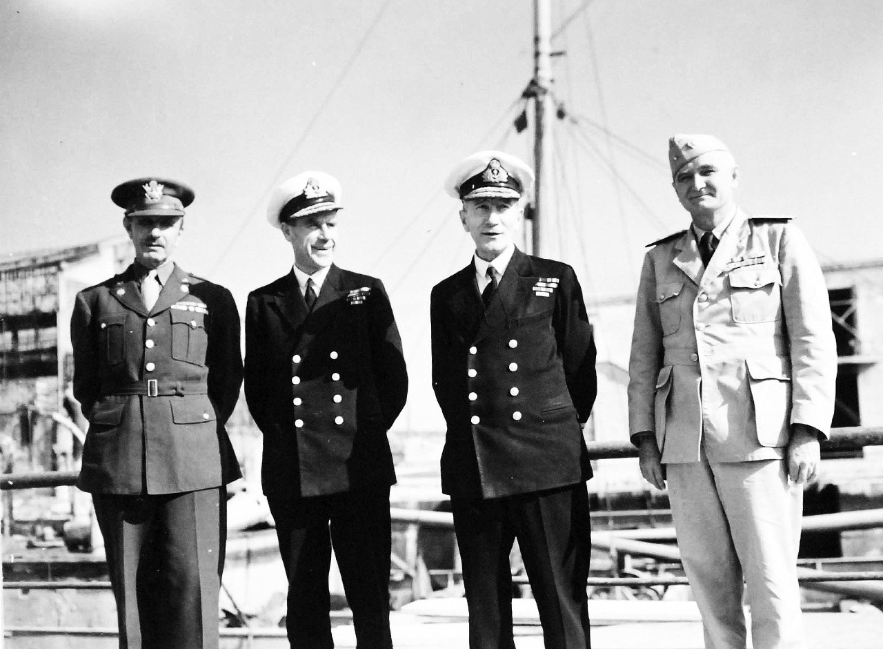 80-G-57188:  Naples, Italy. November 1943.  American and British Officers Tour Naples.   Lieutenant Colonel R. H. Carlson; Rear Admiral Morse; Admiral John Cunningham and Commodore Sullivan at a damaged dry-dock, November 9, 1943.   Offical U.S. Navy Photograph, now in the collections of the National Archives.  (2017/05/02).