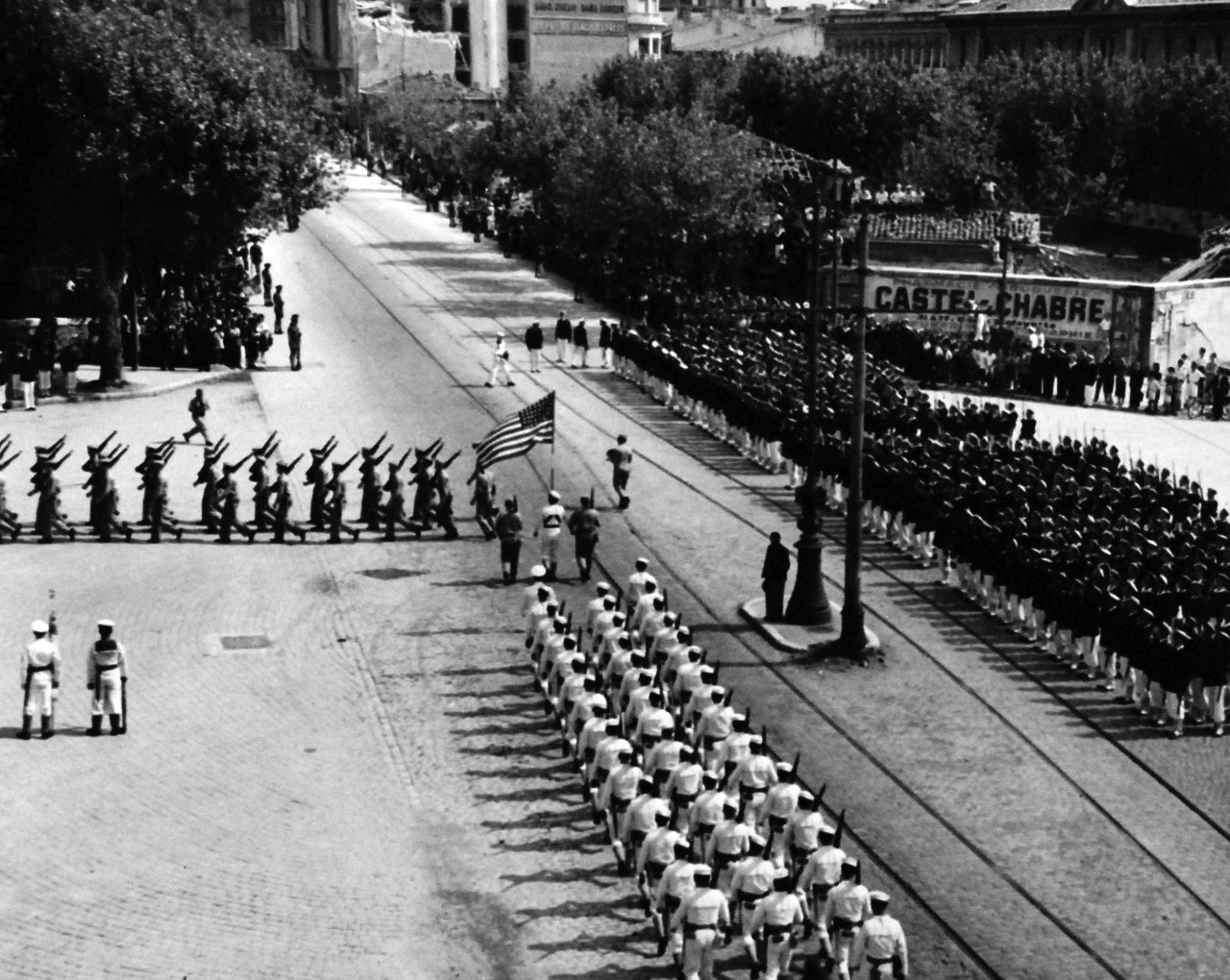 80-G-247152:  Allied Naval units take part in the victory parade in Toulon, France, to celebrate the return of French fleet to the port.   French blue jackets fall in, taken by USS Catoctin (AGC-5), received 14 September 1944.   Note, this specific image has US Marines and Sailors from USS Philadelphia (CL-41) wheel into position before the Toulon War Memorial.  (3/12/2014).