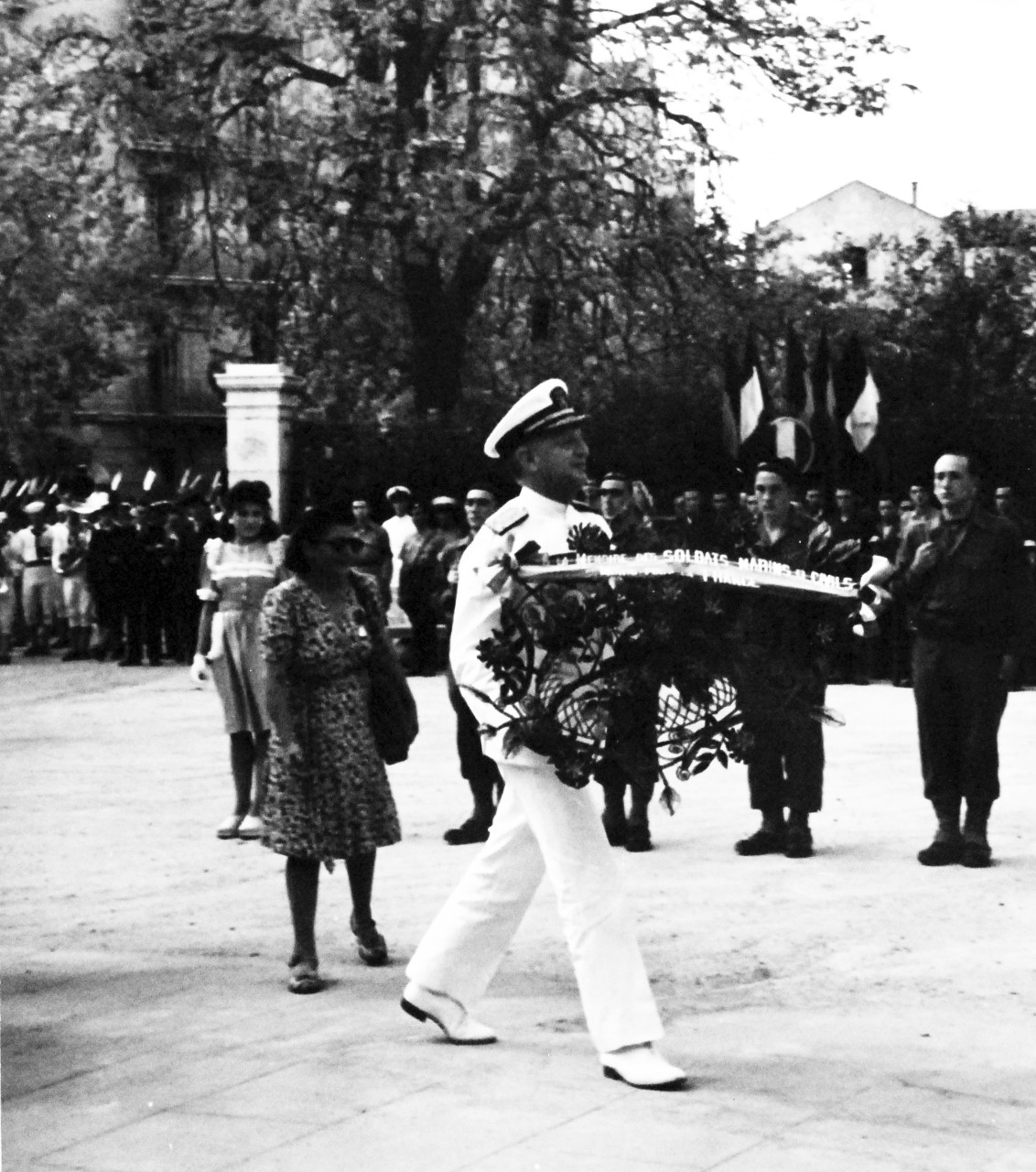 80-G-247154:  Allied Naval units take part in the victory parade in Toulon, France, to celebrate the return of French fleet to the port.   French blue jackets fall in, taken by USS Catoctin (AGC-5), received 14 September 1944.     Vice Admiral H. Kent Hewitt, USN, carries a wreath to the War Memorial at Toulon, France.   (3/12/2014).   