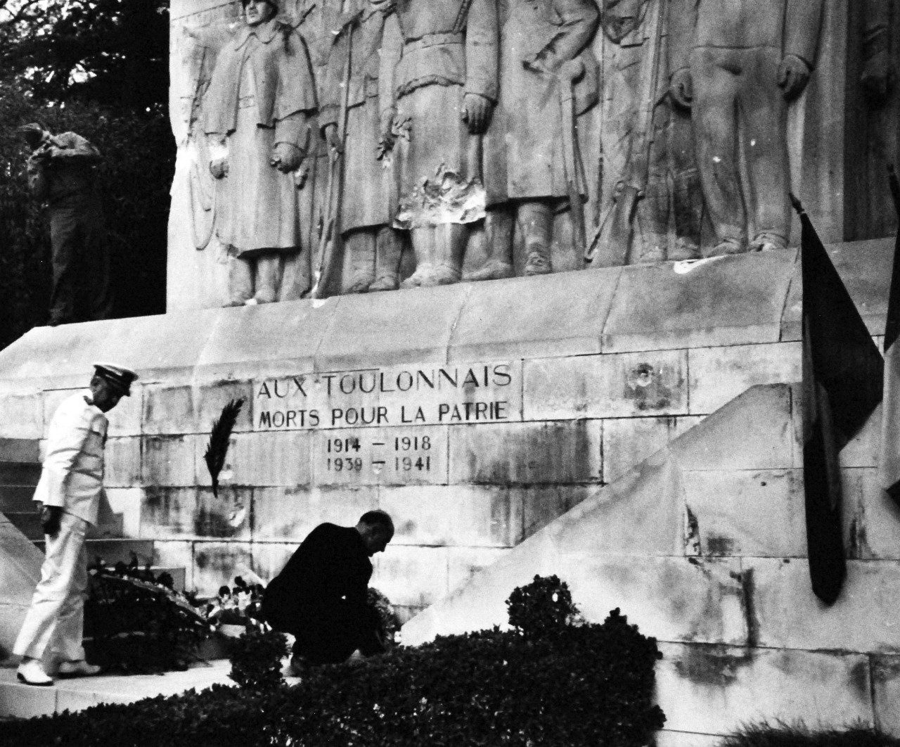 80-G-247155:   High-ranking Allied officers honor the war dead of Toulon, France, before the War Memorial during the celebration of the return of the French Fleet.   Vice Admiral H. Kent Hewitt, USN, lays a wreath at the War Memorial.  Photographed by a crew member of USS Catoctin (AGC-5), received 14 September 1944.   (3/12/2014).   