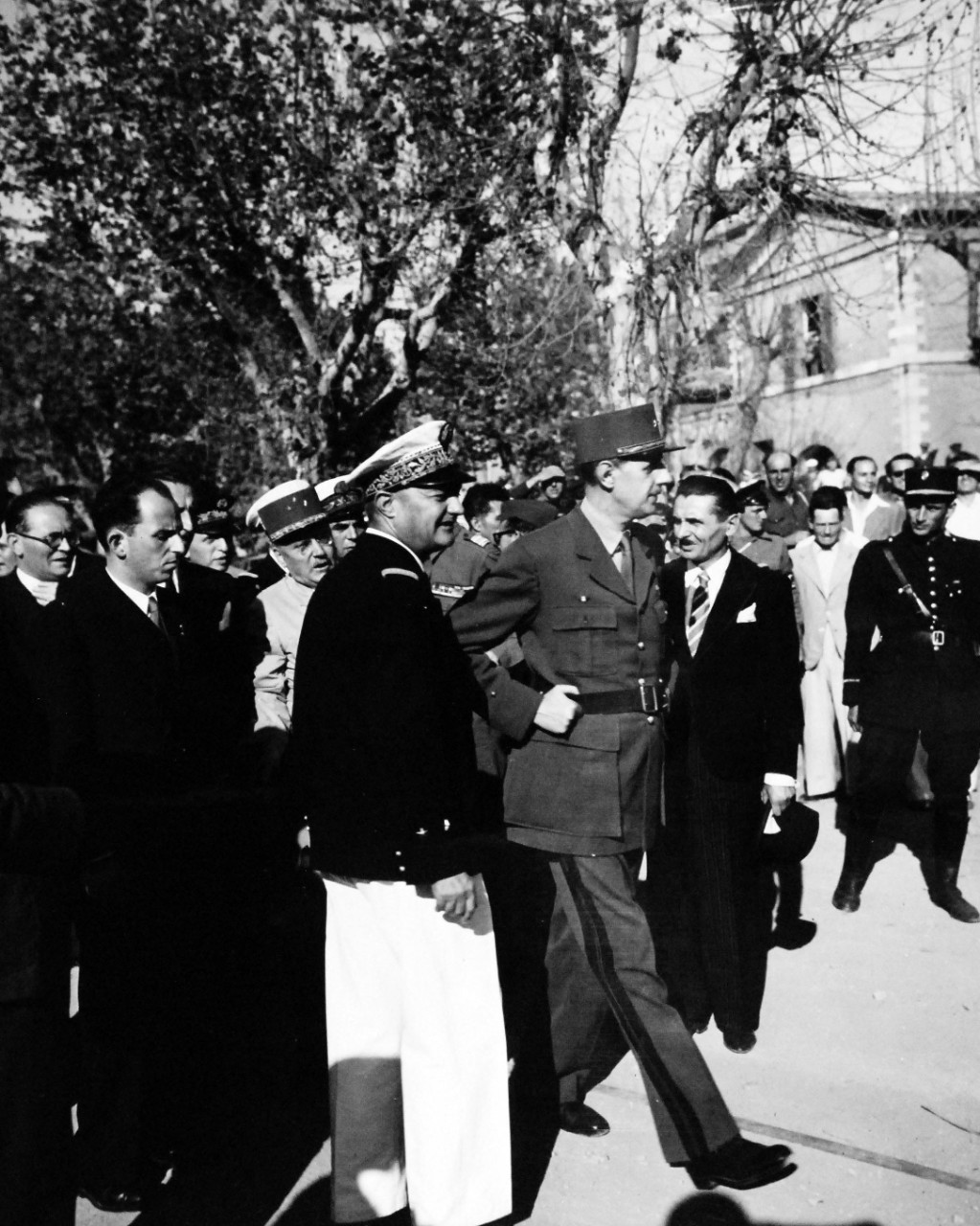 80-G-364097:  Invasion of Southern France, Toulon, August-September 1944.     General Charles de Gaulle at Toulon, France, to inspect the ravaged port areas, 14-15 September 1944.   General de Gaulle returns the salute of French sailors.  Taken by crew of USS Catoctin  (AGC 5).   Official U.S. Navy Photograph, now in the collections of the National Arcchives.    (2014/7/10).