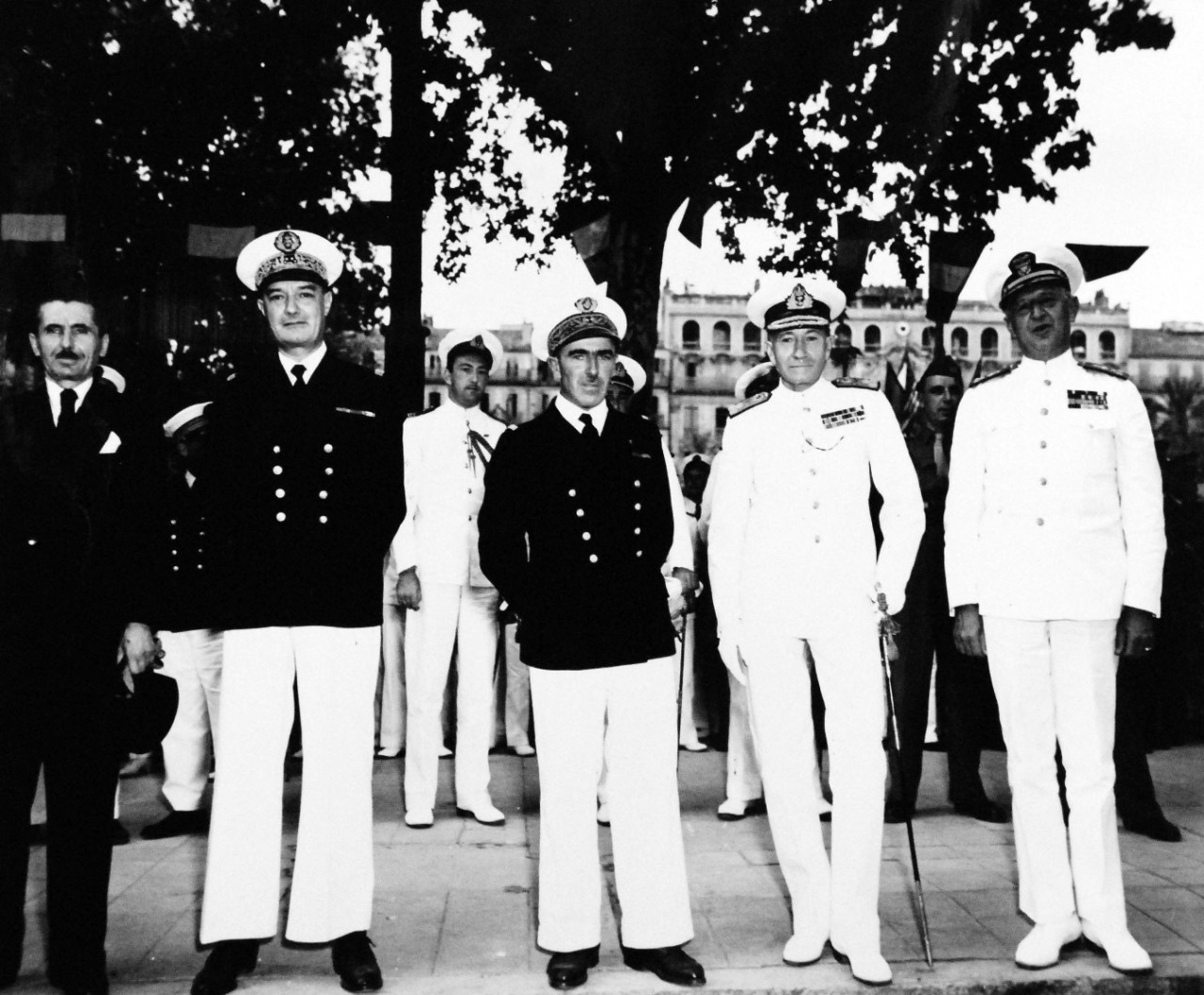80-G-364100:    Invasion of Southern France, Toulon, August-September 1944.   Allied Naval Commanders of the Mediterranean join in victory celebration at Toulon, France, 14 September 1944.  Shown, left to right:  Rear Admiral Lambert; Rear Admiral Andre Lemonnier, Chief of Staff of French Navy; Admiral Sir John H.B. Cunningham, RN, and Vice Admiral H. Kent Hewitt, USN, Commander, Eighth Fleet.   Taken by crew of USS Catoctin  (AGC 5).    Official U.S. Navy Photograph, now in the collections of the National Arcchives.    (2014/7/10).