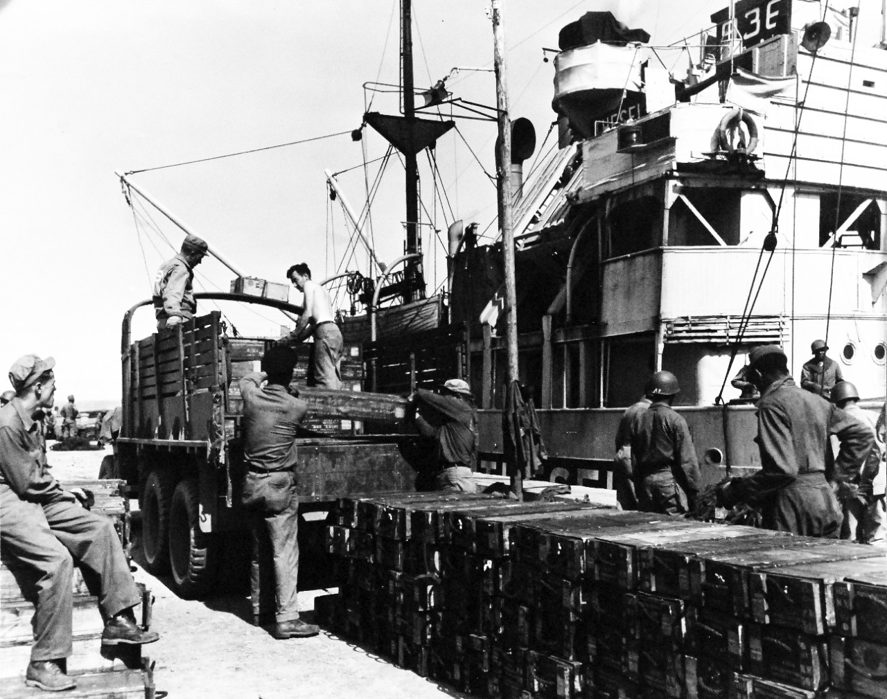 80-G-247134:  Invasion of France, Roscoff, August-September 1944.    Dutch coaster, Theseus, unloads ammunition at port of Roscoff, France, for battle of Brest.   US Navy Seabees and Army men unloading the ammunition, received September 1944.  Official U.S. Navy Photograph, now in the collections of the National Archives.   (2014/3/12).  