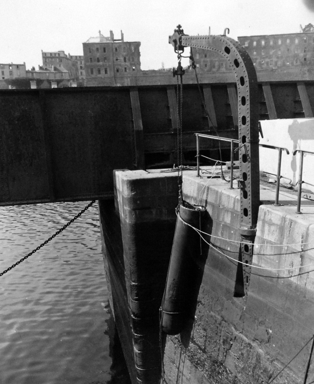 80-G-257439:  Invasion of Southern France, Brest, August-September 1944.   A torpedo warhead hanging against the wall of a basin section in the inner harbor of Brest, France.  It was with such warheads that the Germans demolished harbor installations, 27 September 1944.  (10/28/2014).