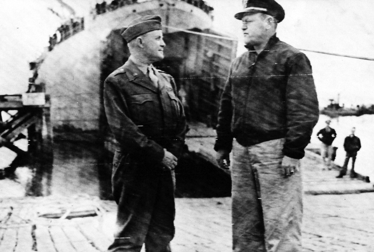 80-G-45668:  Normandy Invasion, June 1944.     Giving last instructions and best wishes, Lieutenant General John C. H. Lee, right-hand man to General Dwight D. Eisenhower, Commander-in-Chief of Allied Forces in Europe, appears in person to a debarkation port during the final loading for the invasion forces.   Photograph released on 6 June 1944.  Official U.S. Navy Photograph, now in the collections of the National Archives.  (2014/9/9).  