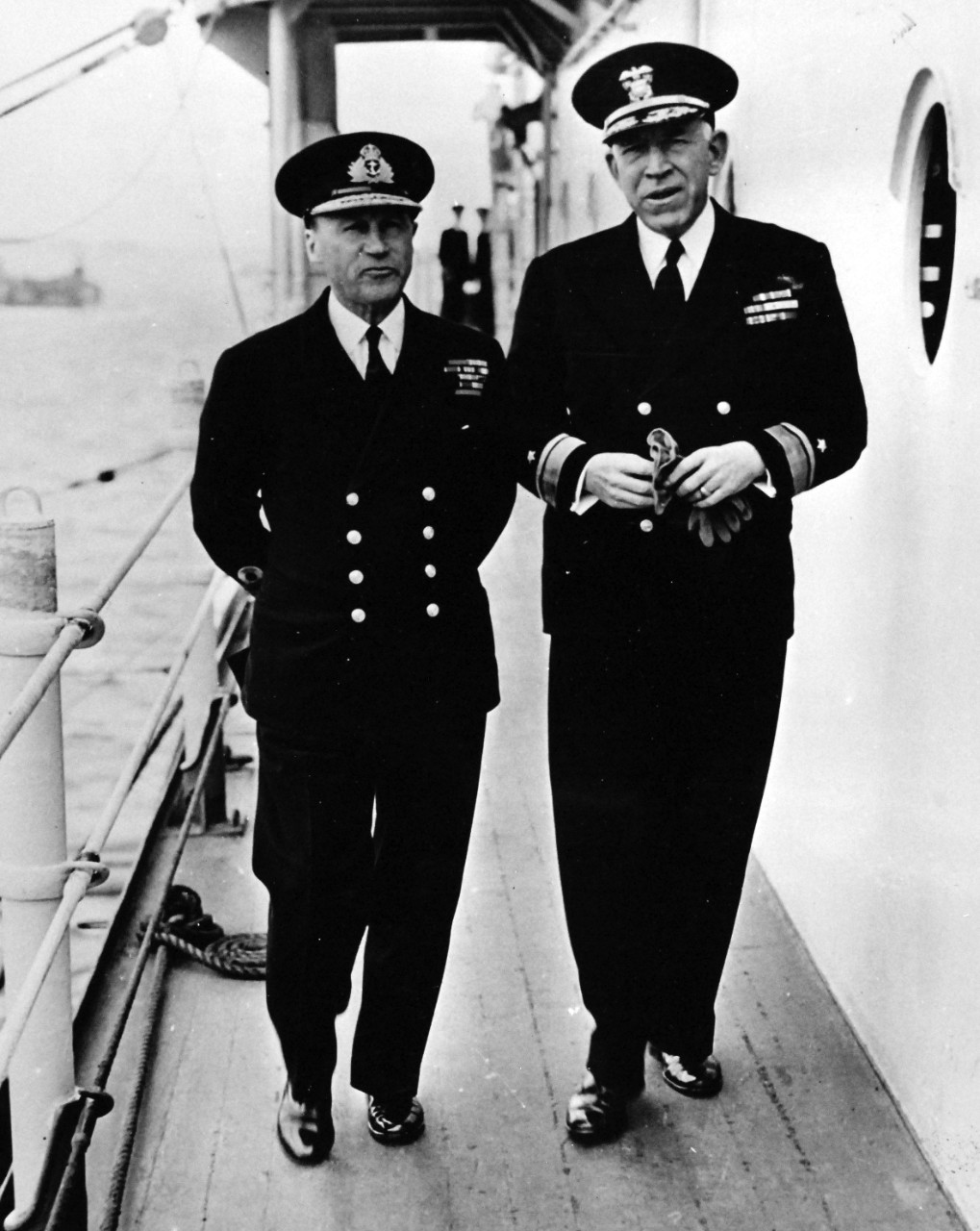 80-G-45713:   Normandy Invasion, June 1944.   Rear Admiral John L. Hall, USN, (right), and Admiral Sir Bertram Ramsay, Commander-in-Chief of Allied Naval Forces, stroll about a U.S. warship shortly before the vessel went into action against Nazi shore batteries on D-Day.   Photographed on 10 June 1944.  Official U.S. Navy Photograph, now in the collections of the National Archives.  (2014/9/9).  