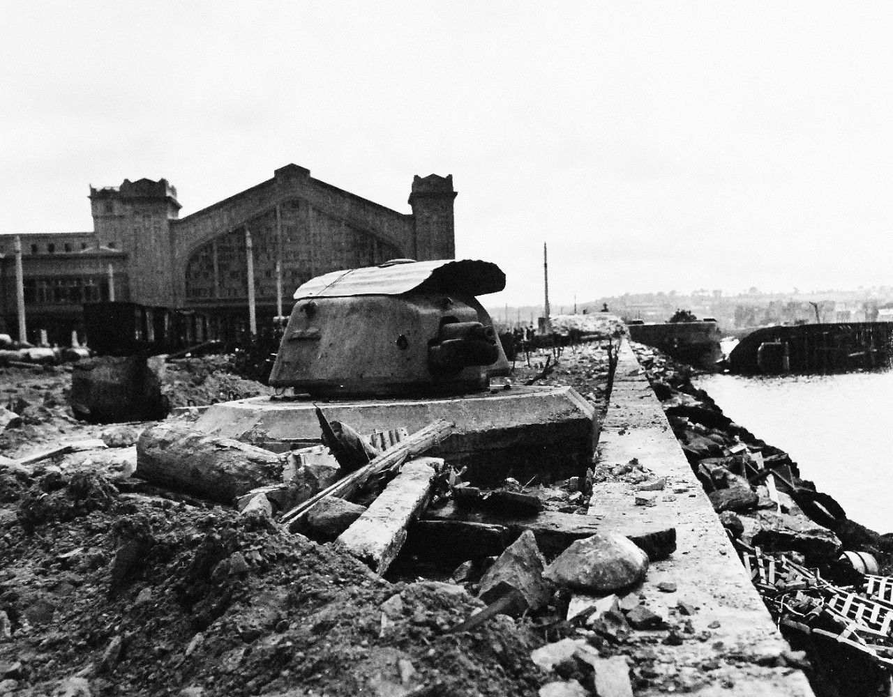 80-G-255934:  Normandy Invasion, Cherbourg, France, July 1944.    French ship SS Mormano lies on her side off Place de Napoleon, Cherbourg, France.  The water front covered with debris shows the severity of the Allied bombardment.   Photographed by CPU-11, 4 July 1944.  Official U.S. Navy Photograph, now in the collections of the National Archives.   (2014/11/05). 
