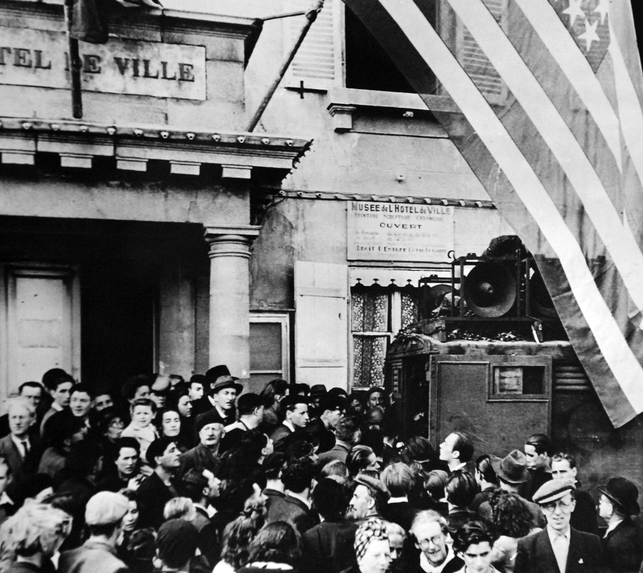 Lot 11611-15:   Liberation of France, World War II.  Civilians crowd in around an Allied broadcasting truck outside the city hall during the liberation ceremonies.  Cherbourg, France, summer 1944.    Office of War Information Photograph by Weston Hayes, 28370. Courtesy of the Library of Congress.  (2016/02/25)