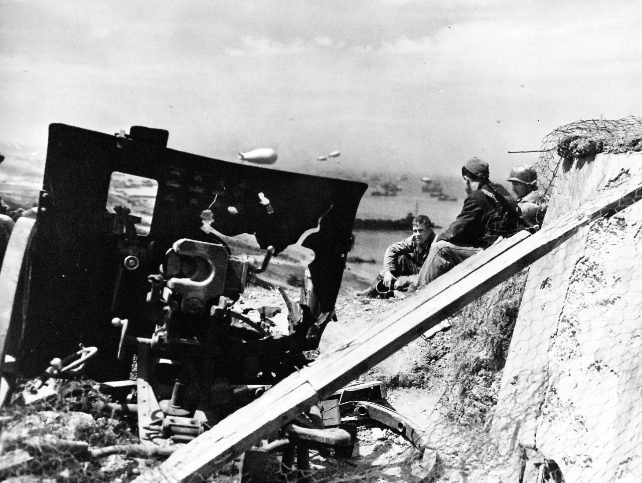 80-G-285217:  Normandy Invasion, June 1944. A German gun position on beach of Normandy, France, destroyed by Naval gunfire.  In background are Allied ships.  Photograph released November 7, 1944.  U.S. Navy photograph, now in the collections of the National Archives.  (2016/03/15).