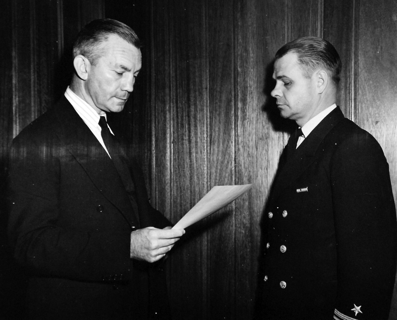 80-G-46614:  Secretary of the Navy James V. Forrestal presents to Lieutenant Commander Joseph H. Gibbons, Jr., USNR, a Presidential Unit Citation for clearing lanes on the heavily mined Normandy shoreline for a landing force of Allied troops on D-Day, June 6, 1944.  Released September 27, 1944.  U.S. Navy Photograph, now in the collections of the National Archives.  (2016/06/07).
