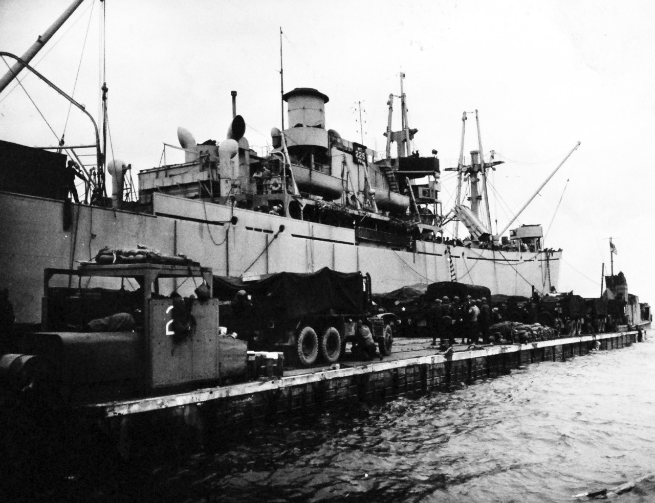 80-G-252653:  Normandy Invasion, Rhino Ferry, June 1944.    A Rhino barge, married to a transport off the French coast, takes on a load of trucks and troops to reinforce armies moving inland, 10 June 1944.   Official U.S. Navy Photograph, now in the collections of the National Archives.   (2014/10/28). 