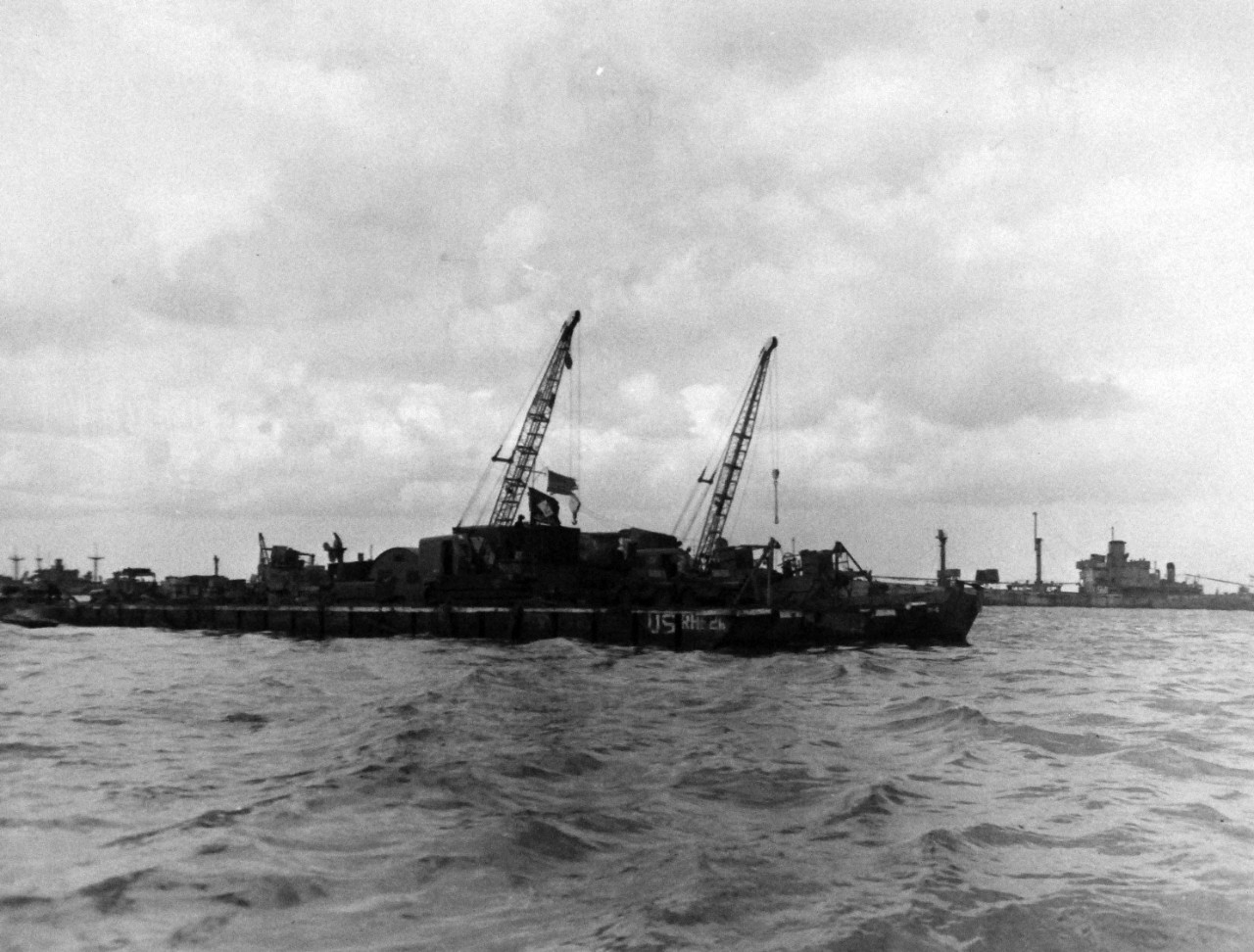 80-G-285125:  Normandy Invasion, Mulberries, June 1944.   Rhino barges carrying equipment to invasion beach of Normandy, France.  In background is a section of “Gooseberry,” purposely sunk ships forming part of the “Mulberry,” the man-made harbor.  Photograph released November 7, 1944.  U.S. Navy photograph, now in the collections of the National Archives.  (2016/03/15).