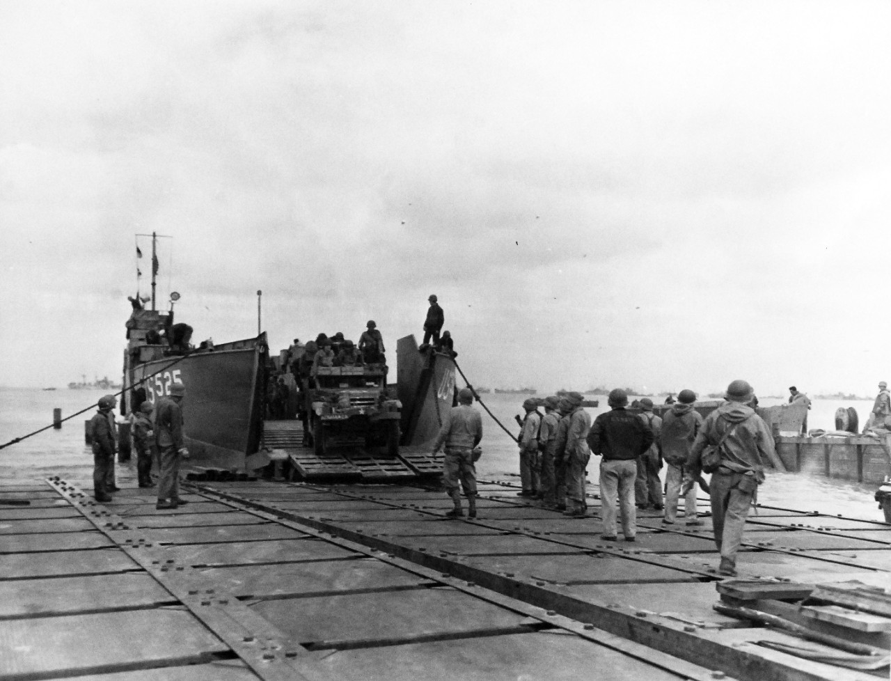 80-G-285136:  Normandy Invasion, Mulberries, June 1944.   The pontoon causeway at “Utah” beach, forming part of the U.S. Mulberry the man-made harbor off coast of France, built to protect landing craft from storms in English Channel.  Note LCT 525. Photograph released November 7, 1944.  Official U.S. Navy photograph, now in the collections of the National Archives.  (2016/03/15).