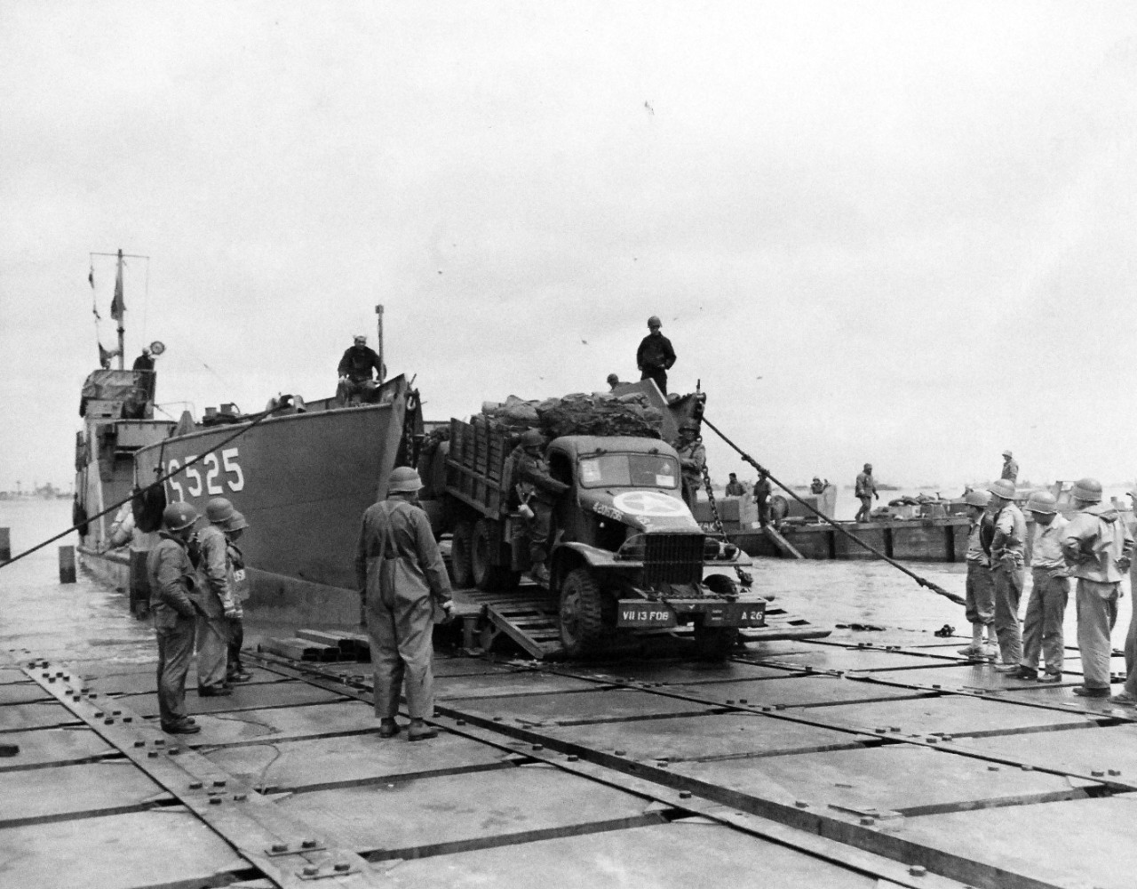 80-G-285137:  Normandy Invasion, Mulberries, June 1944.   The pontoon causeway at “Omaha” beach, forming part of the U.S. Mulberry the man-made harbor off coast of France, built to protect landing craft from storms in English Channel.  Note LCT 525. Photograph released November 7, 1944.  Official U.S. Navy photograph, now in the collections of the National Archives.  (2016/03/15).