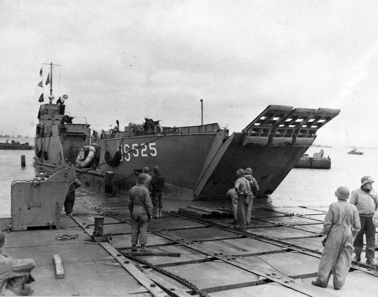 80-G-285138:  Normandy Invasion, Mulberries, June 1944.     The pontoon causeway at “Omaha” beach, forming part of the U.S. Mulberry the man-made harbor off coast of France, built to protect landing craft from storms in English Channel.  Note LCT 525. Photograph released November 7, 1944.  Official U.S. Navy photograph, now in the collections of the National Archives.  (2016/03/15).