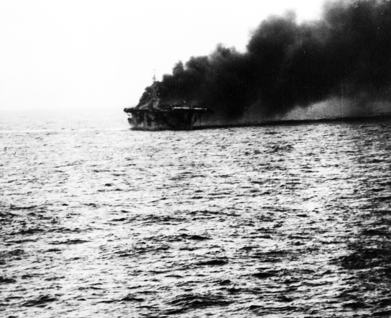 80-G-270512:  USS St. Lo (CVE-63), October 25, 1944.  St. Lo burning after being hit by a Japanese suicide plane off Leyte Gulf, Philippines.  Taken from USS Kalinin Bay (CVE-68).  Official U.S. Navy photograph, now in the collections of the National Archives.  