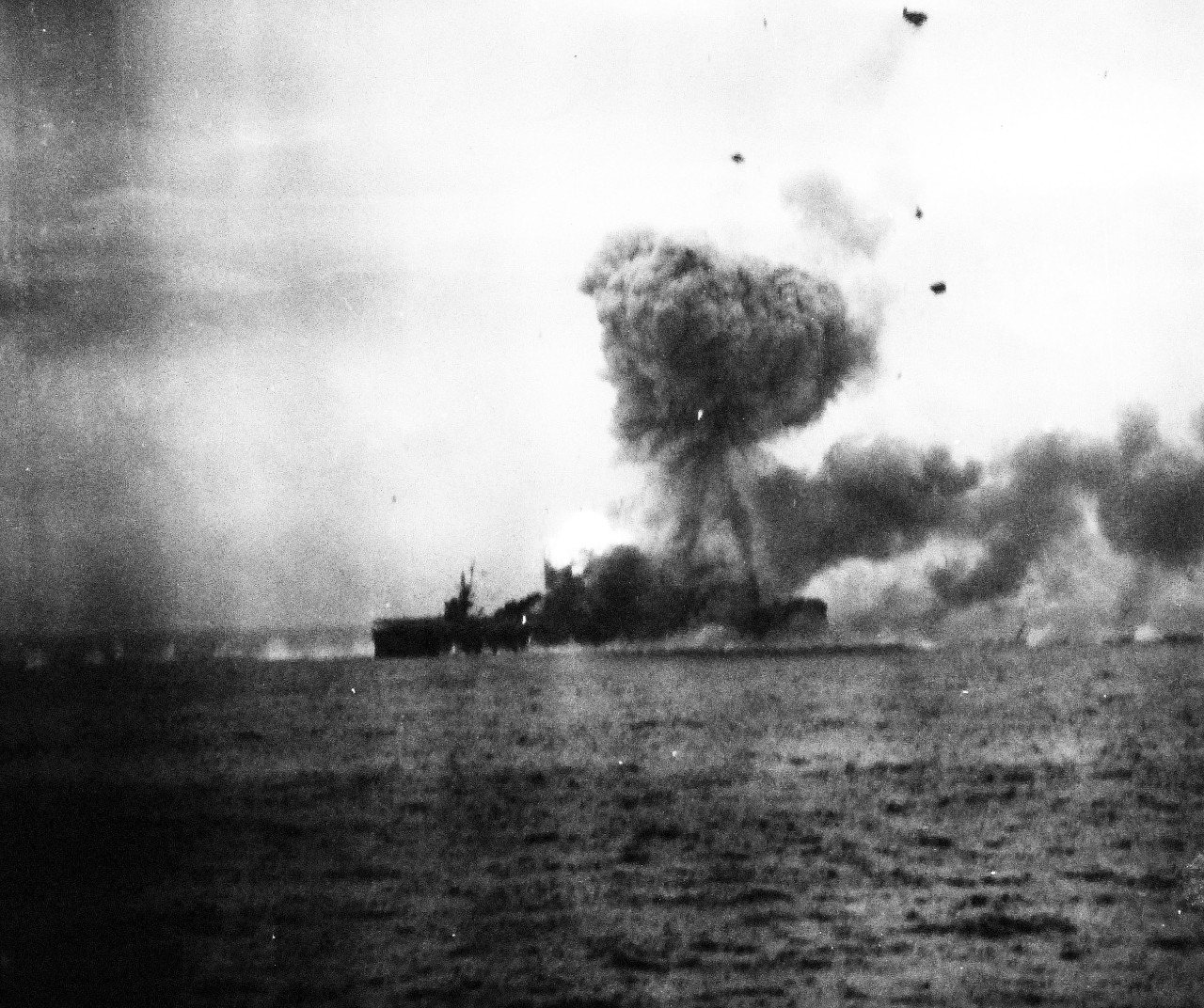 80-G-270513:  USS St. Lo (CVE-63), October 25, 1944.  St. Lo burning after being hit by a Japanese suicide plane off Leyte Gulf, Philippines.  Taken from USS Kalinin Bay (CVE-68).   View shows the moments after the second explosion.  Official U.S. Navy Photograph, now in the collections of the National Archives.  